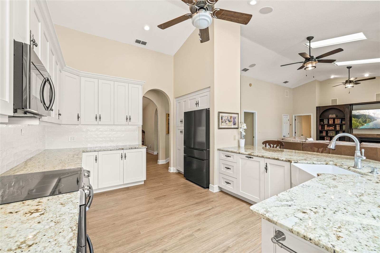 Completely remodeled kitchen with custom cabinets, granite countertops, massive breakfast bar and all new appliances.