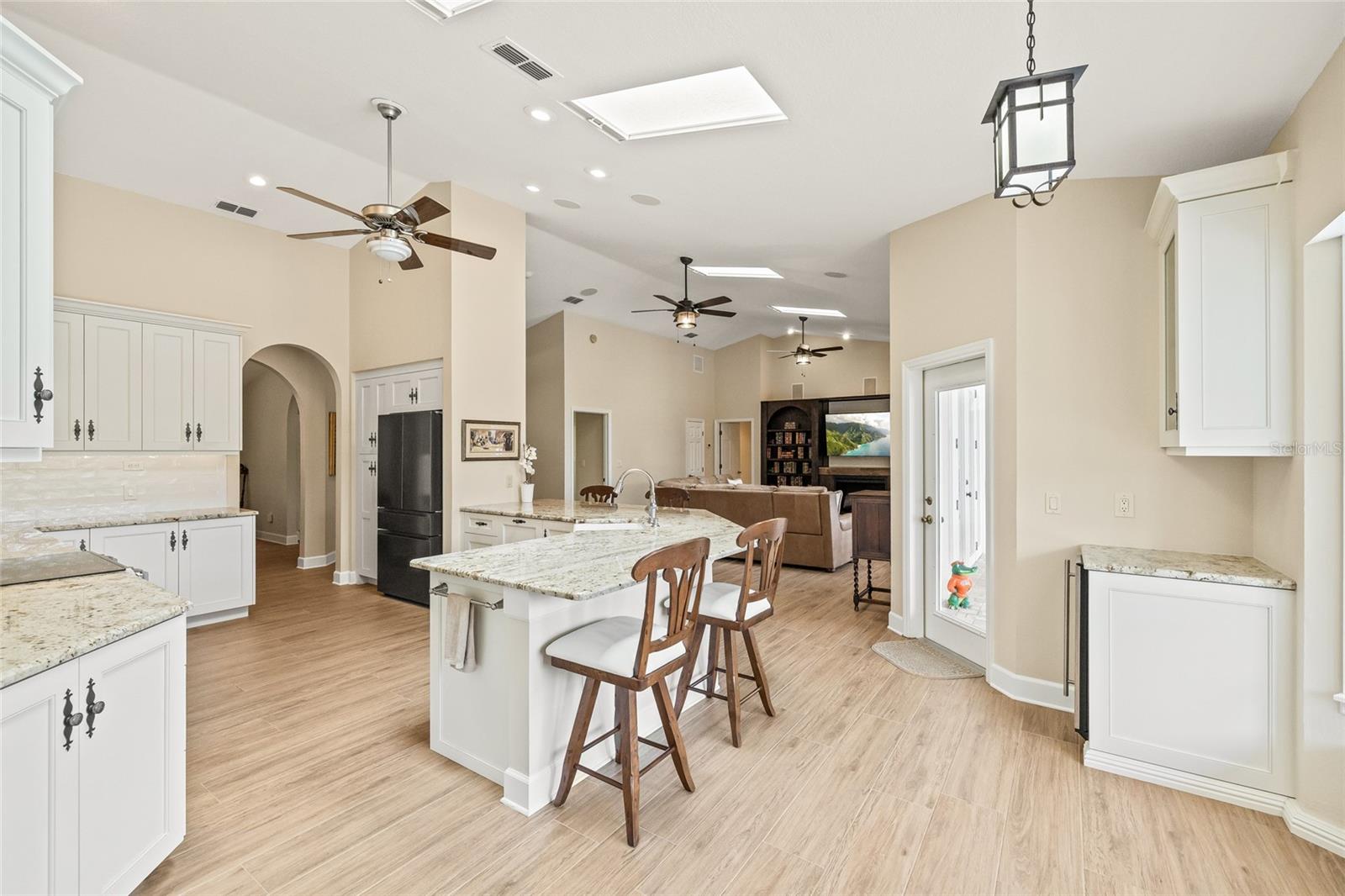 The kitchen anchors the living room and dining room. All with beautiful lake views.