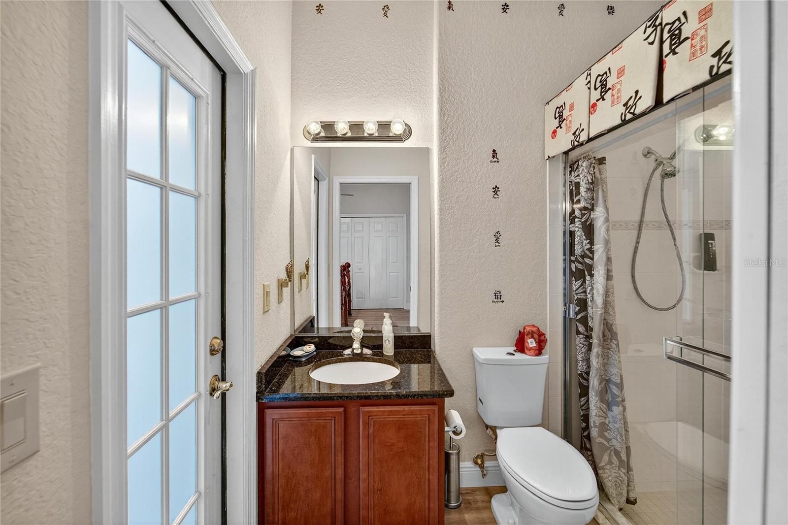 Guest en-suite bathroom with access to lanai/pool