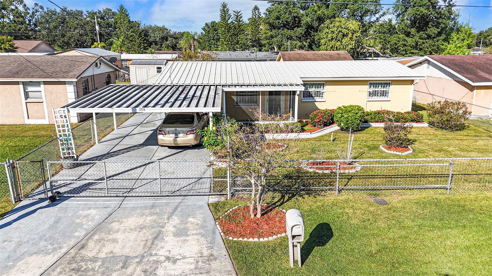 Welcome home! 2-car covered parking enclosed by an electric fence
