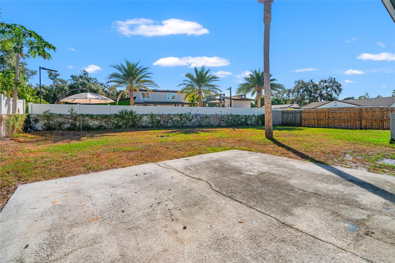 Fenced in yard with patio slab