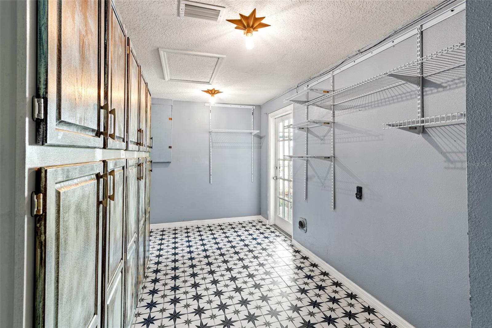 Utility/Laundry Room with Storage Cabinets and access to side yard