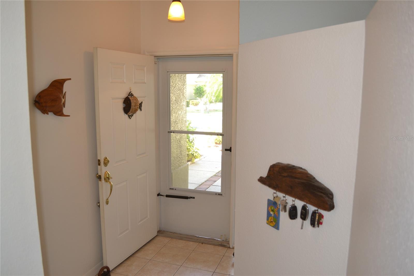 Foyer is spacious, large closet and entrance to garage