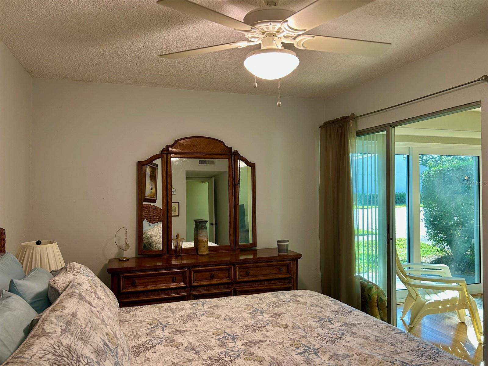 Primary Bedroom With Sliders To Florida Room