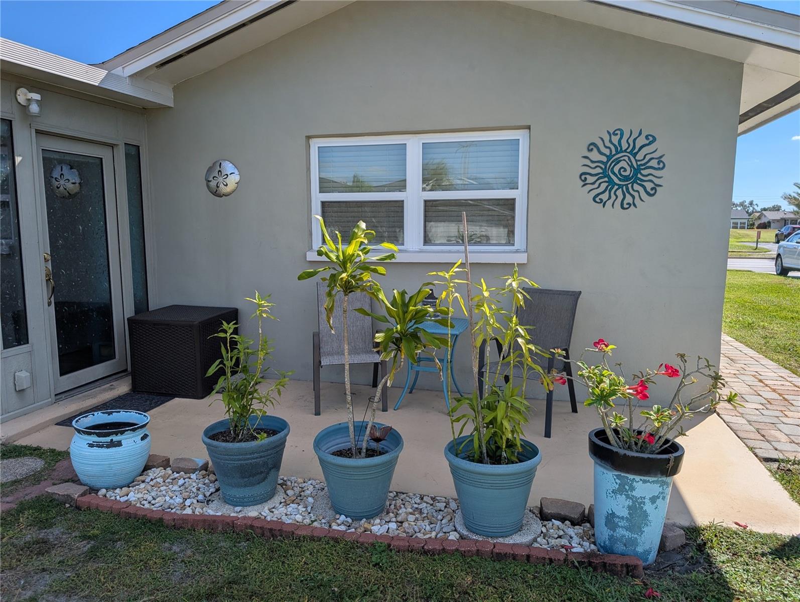 Exterior view of back patio and Florida room access. Notice paver walkway around house.