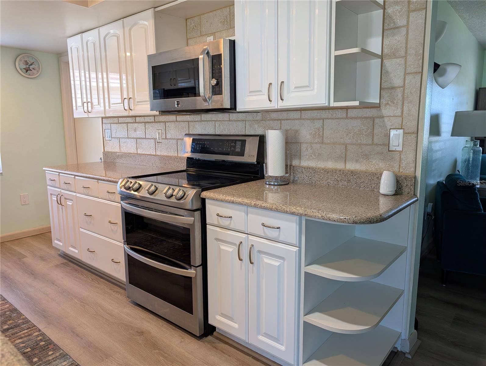 View of garage door entry into kitchen (end of counter to left of range).