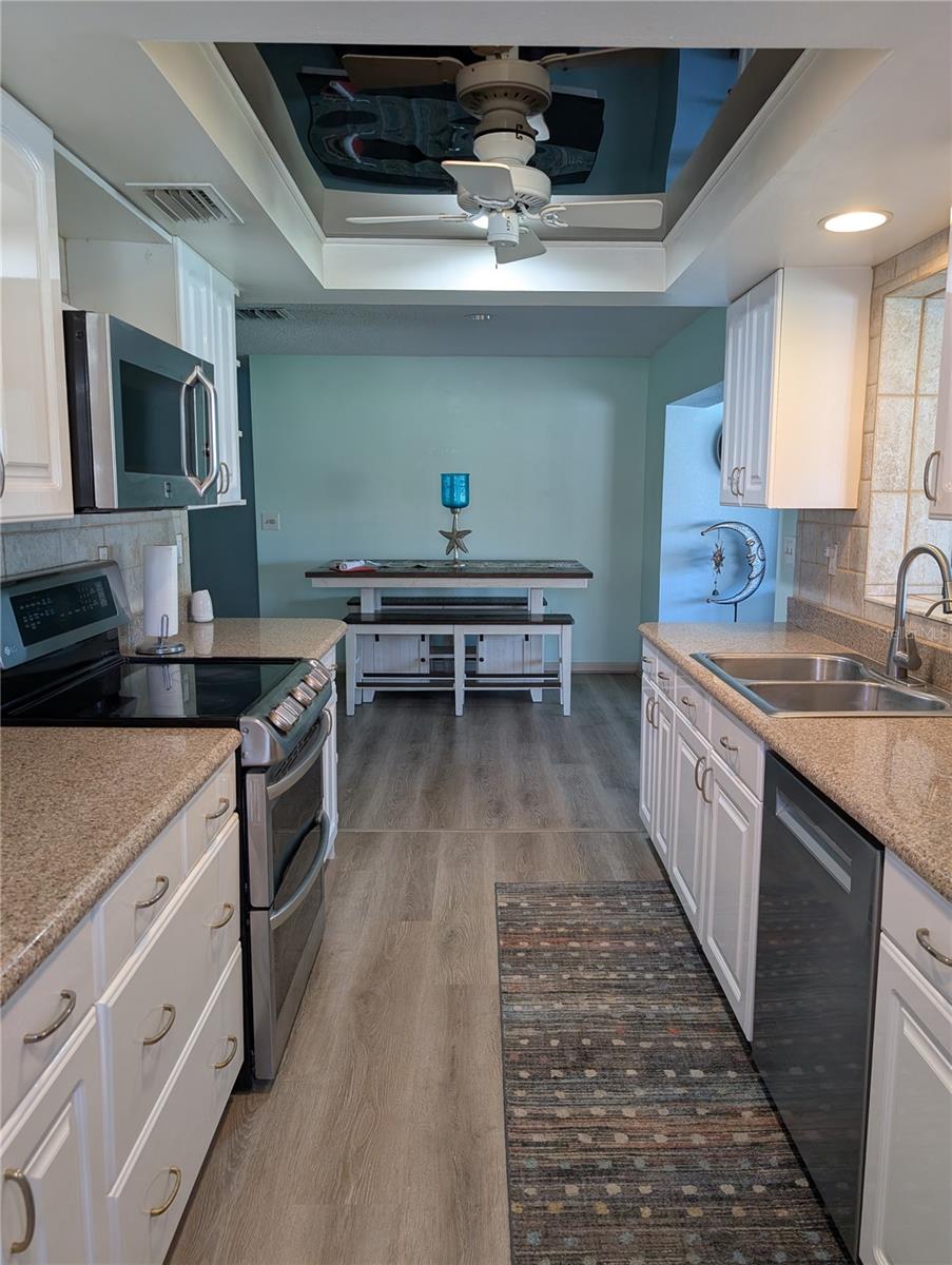 View from garage entry thru kitchen into dining area.  Florida room to right and living room to left.