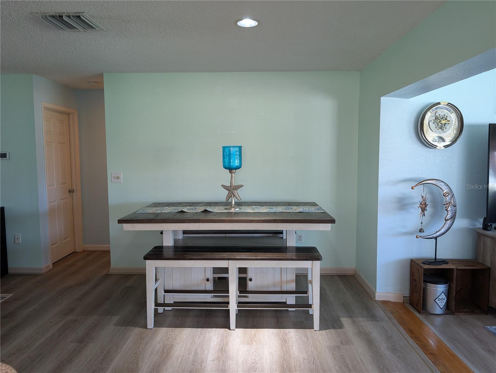 View of dining room.  Hallway to both bathrooms & bedrooms to left of table.