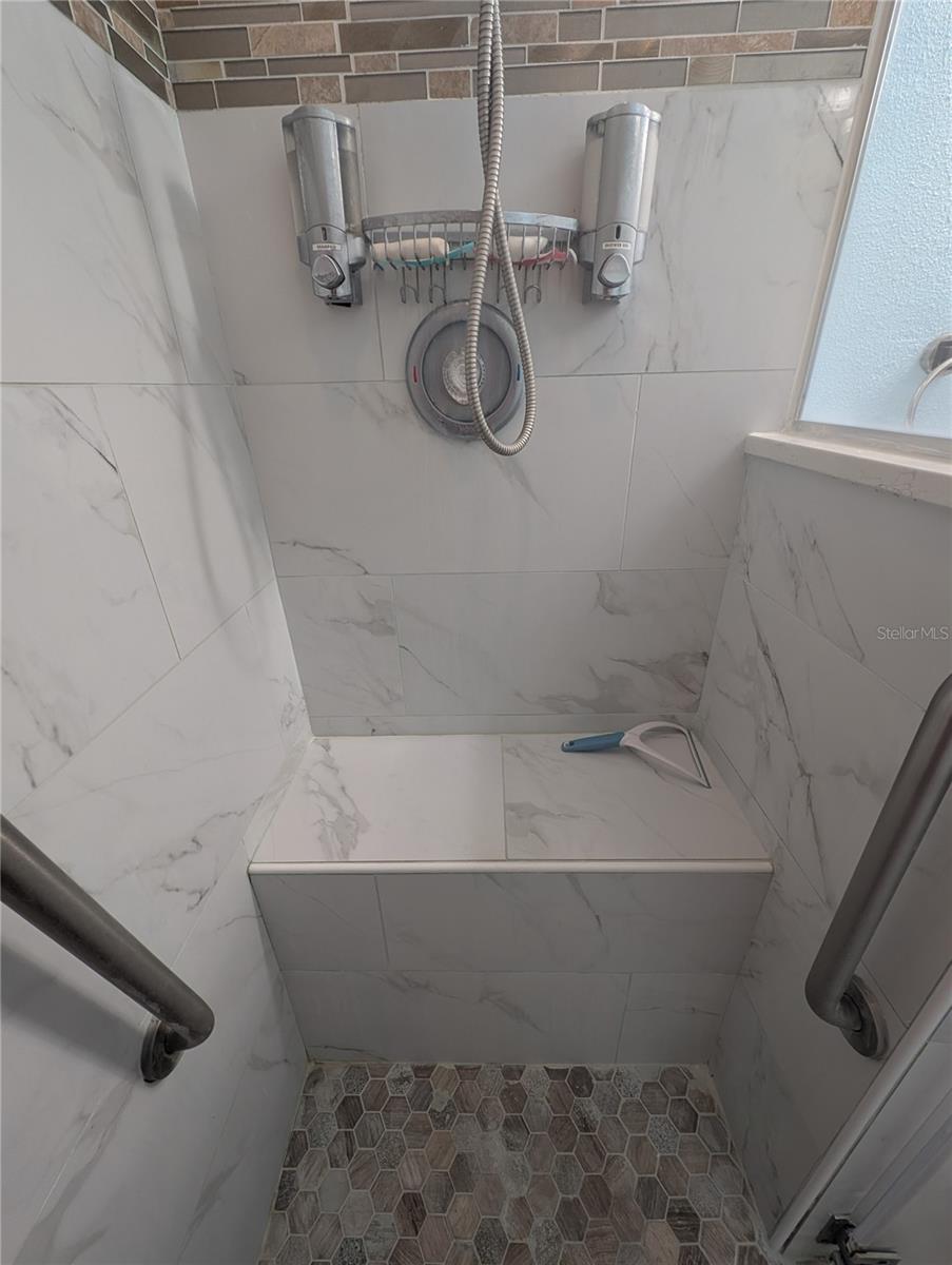 Pebble tile shower floor and bench seat.