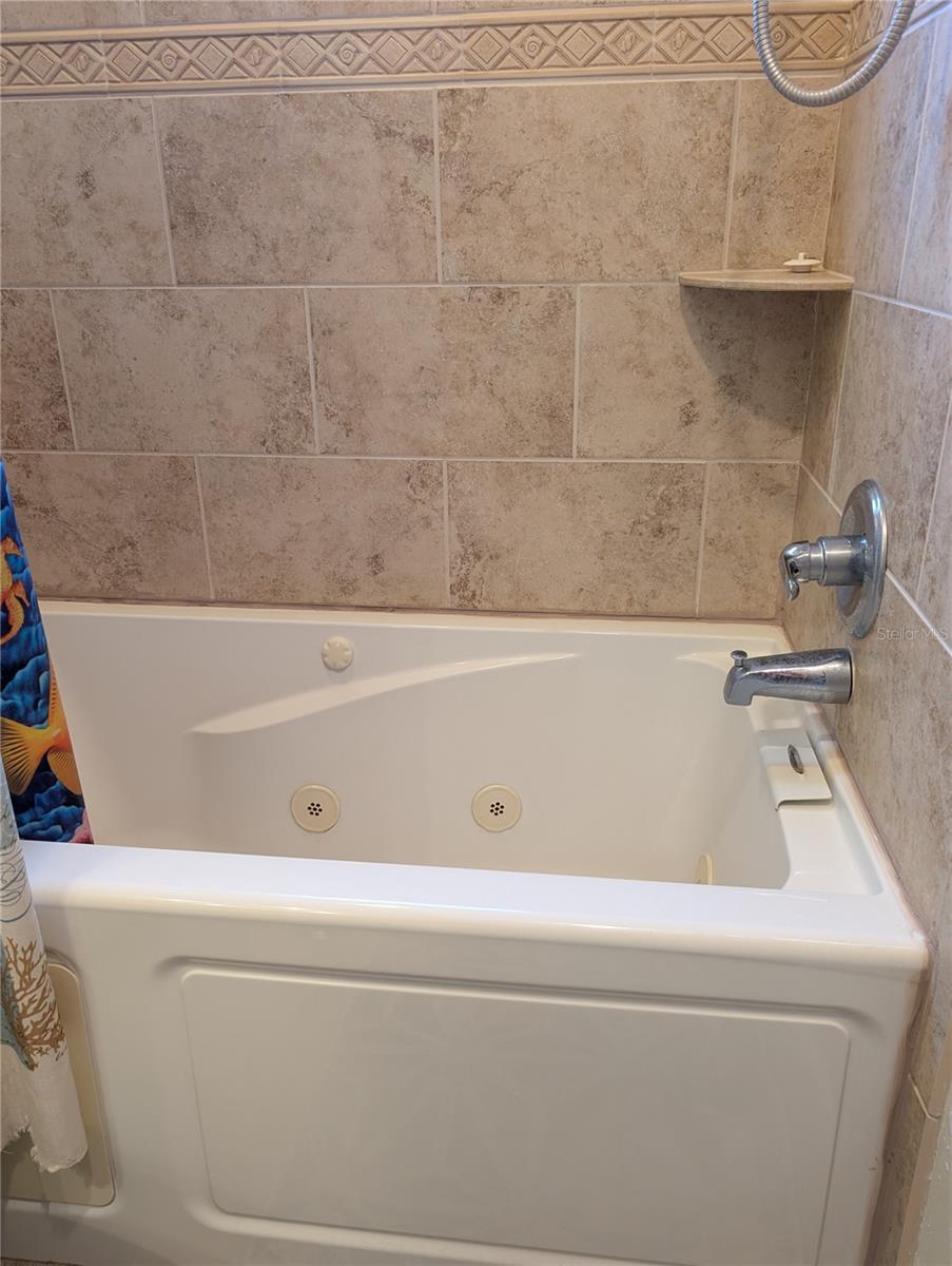 A jetted bathtub w/gorgeous tile tub surround for a relaxing soak.