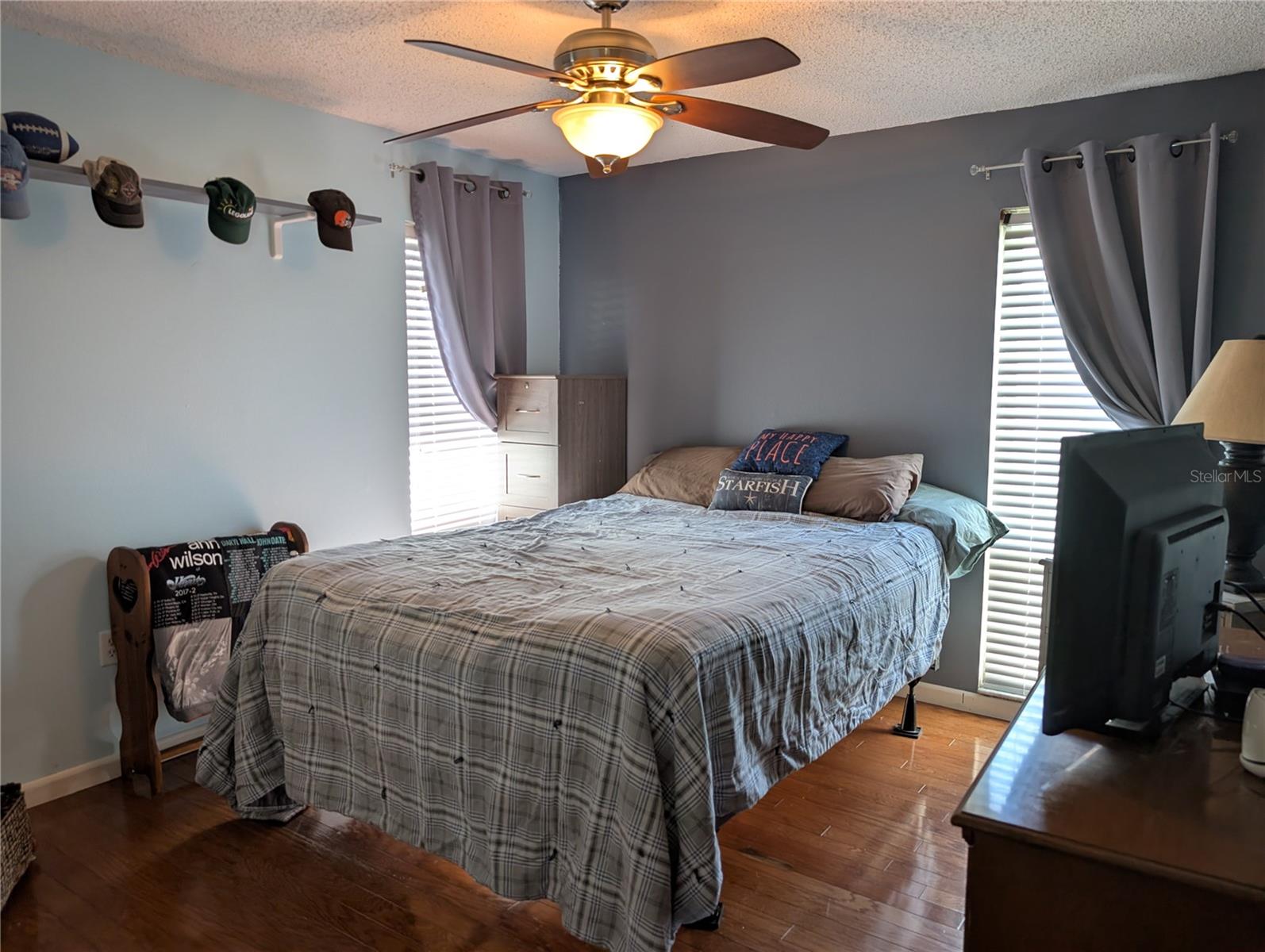 Guest bedroom features include rich hardwood flooring, new closet doors, ceiling fan and faux 2"wood blinds.