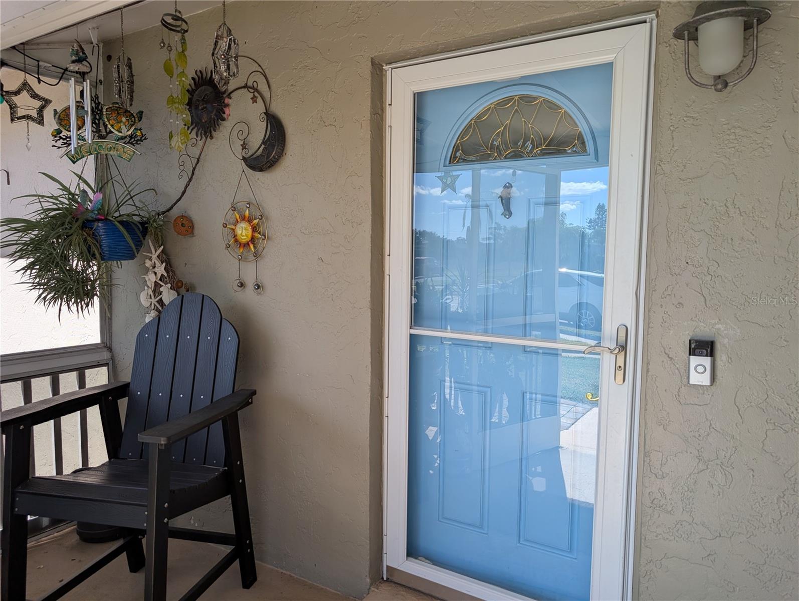 Front entry into screened porch is a little oasis to enjoy the outdoor tropical lifestyle in all types of weather.