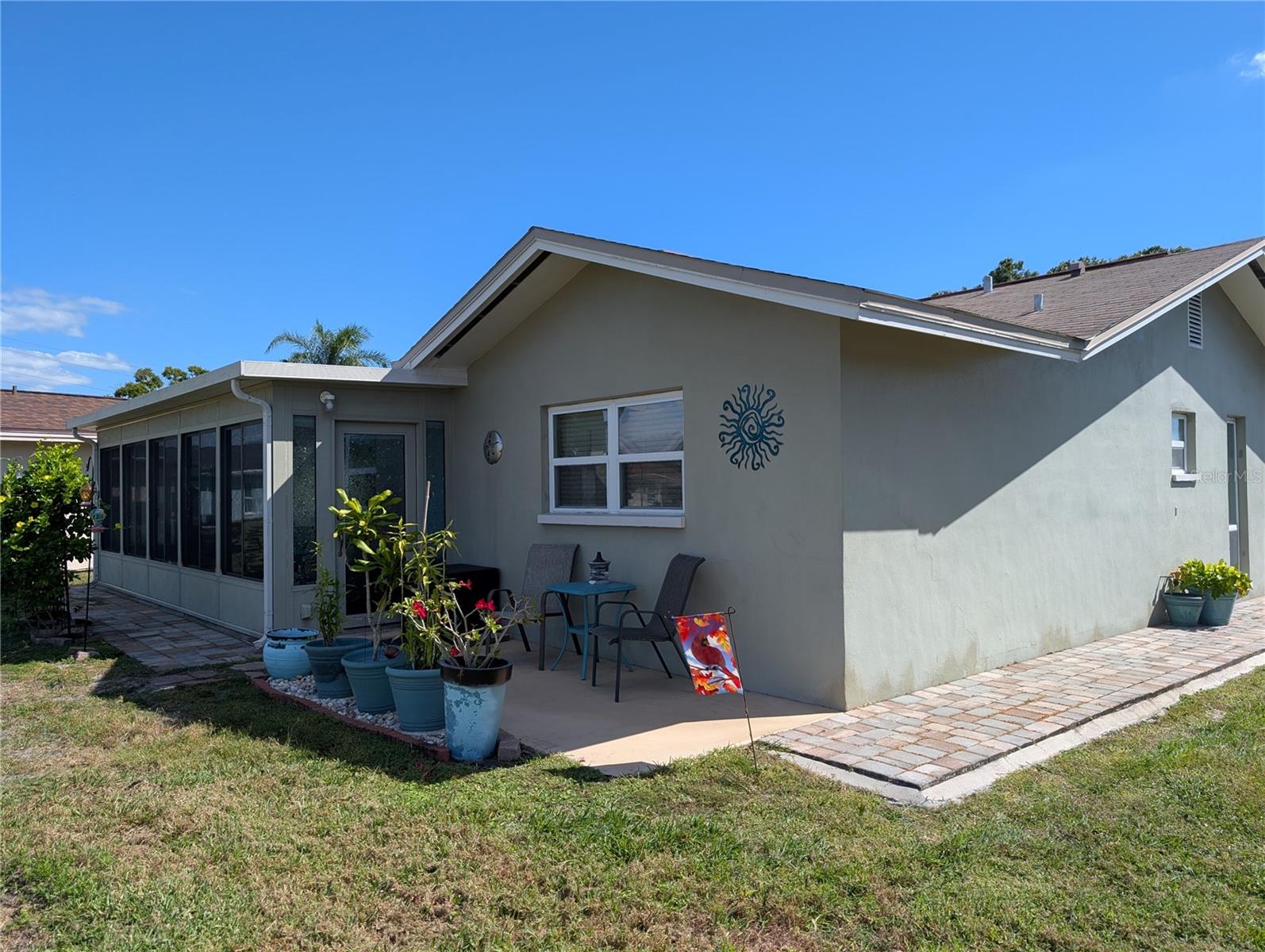 Exterior view of back open patio and Florida room.