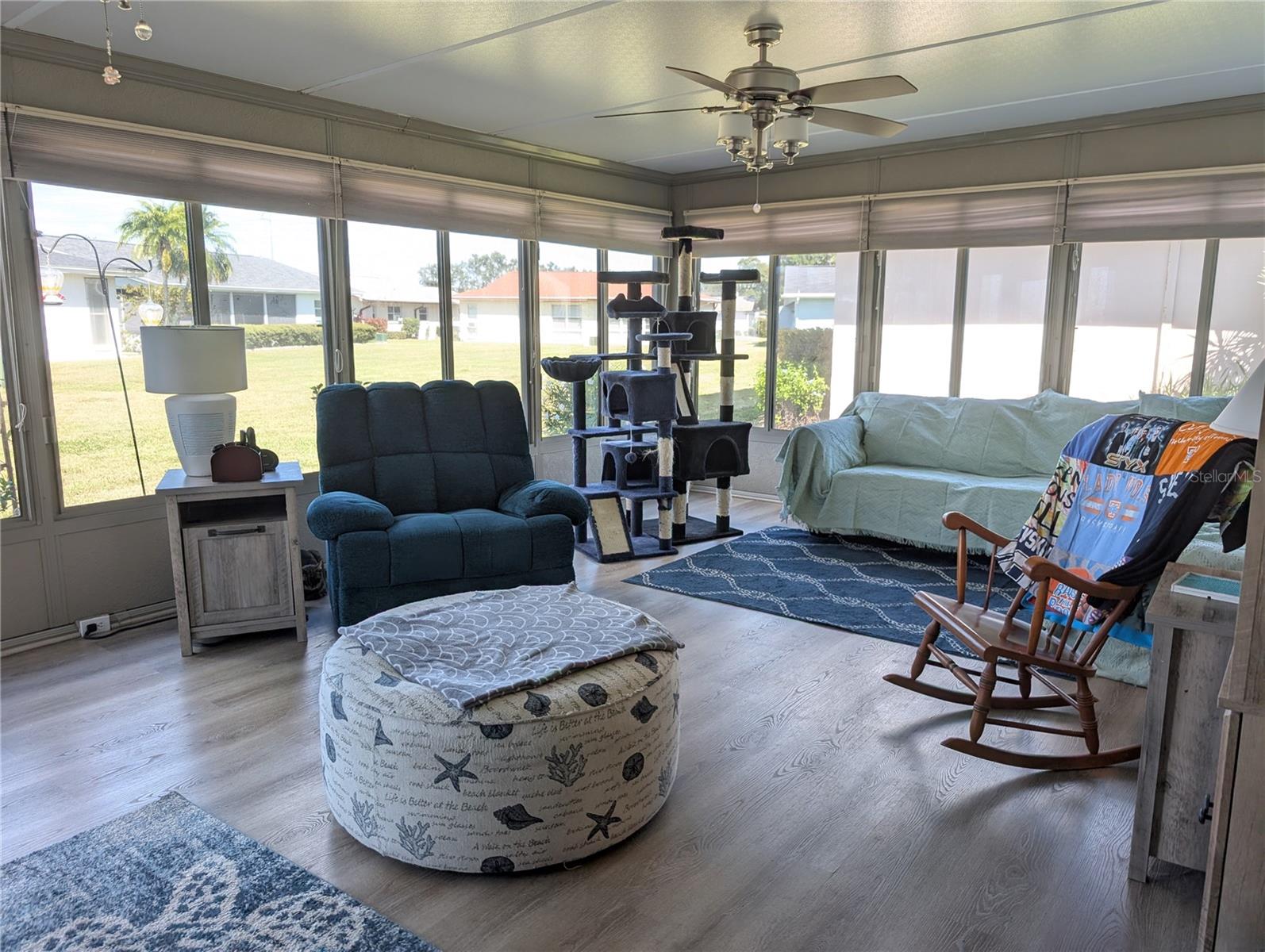 Florida room explodes with natural light and airflow... "a Wall of Windows."  Awesome backyard view.