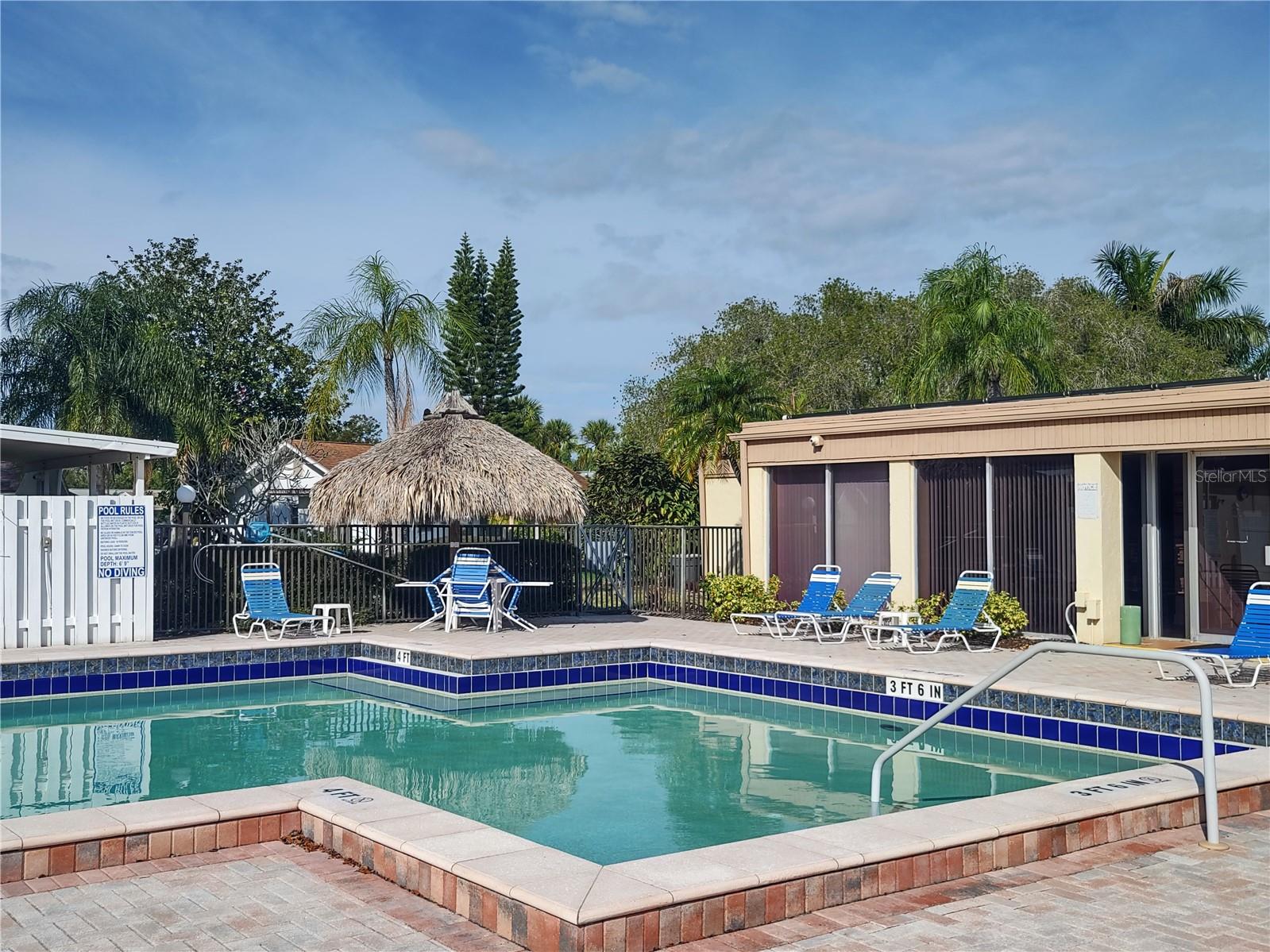 Pool area has a tropical flair.
