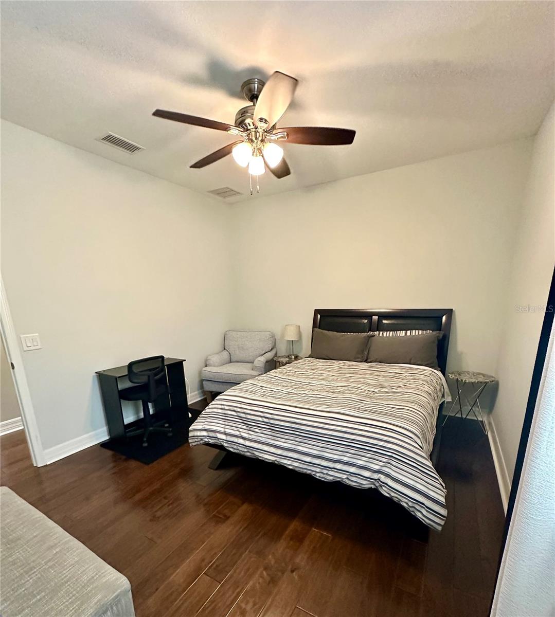 Bedroom 4 With Queen Bed, Chair, & Desk