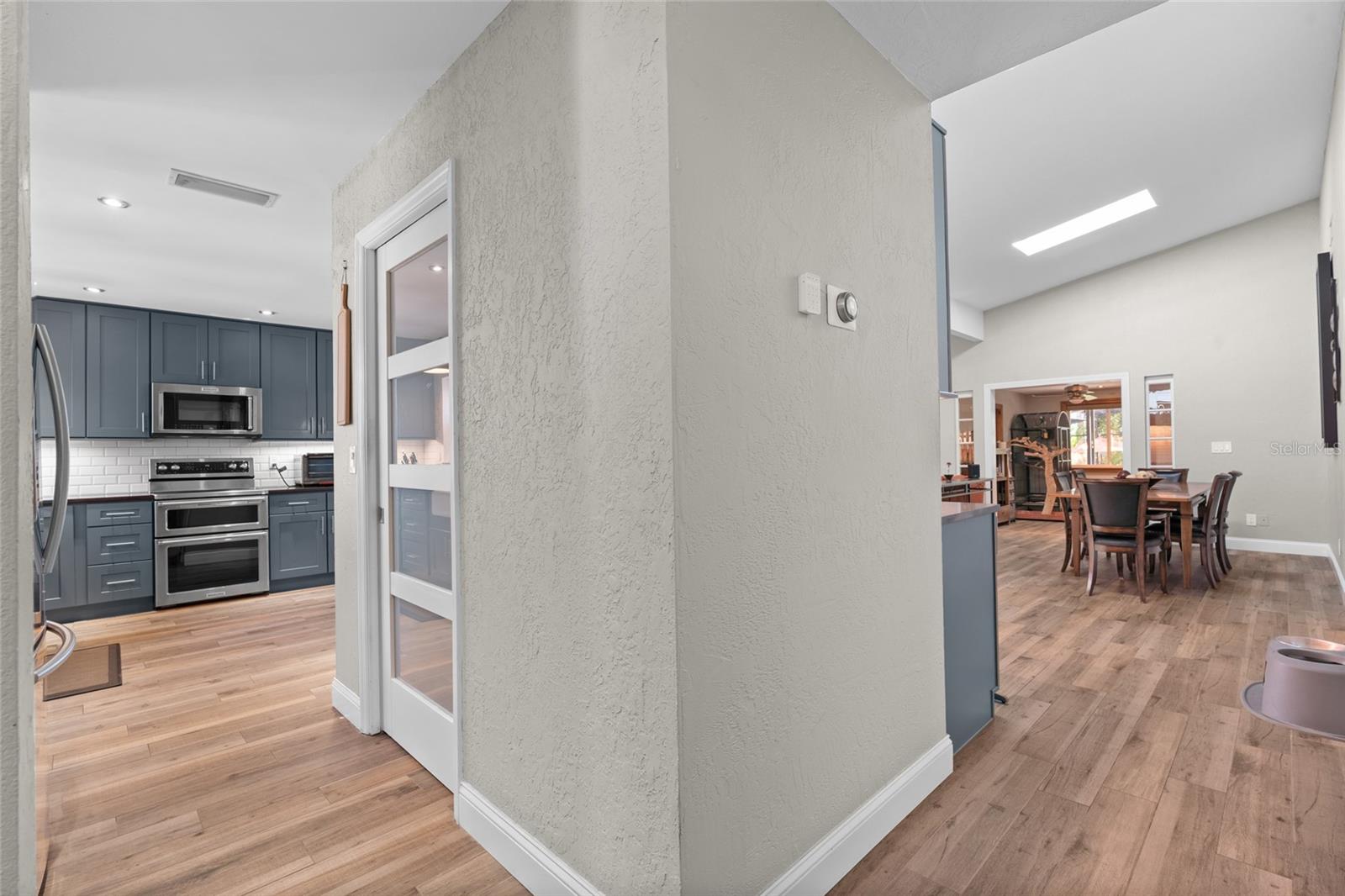 AS YOU ENTER THE HOME, YOU MAKE AN IMMEDIATE LEFT INTO THE KITCHEN AND LAUNDRY ROOM.