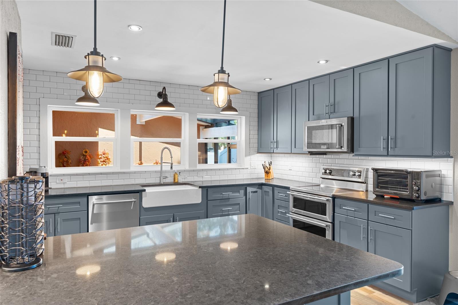 BEAUTIFULL QUARTZ COUNTERTOPS AND SLATE/BLUE WOOD CABINETS