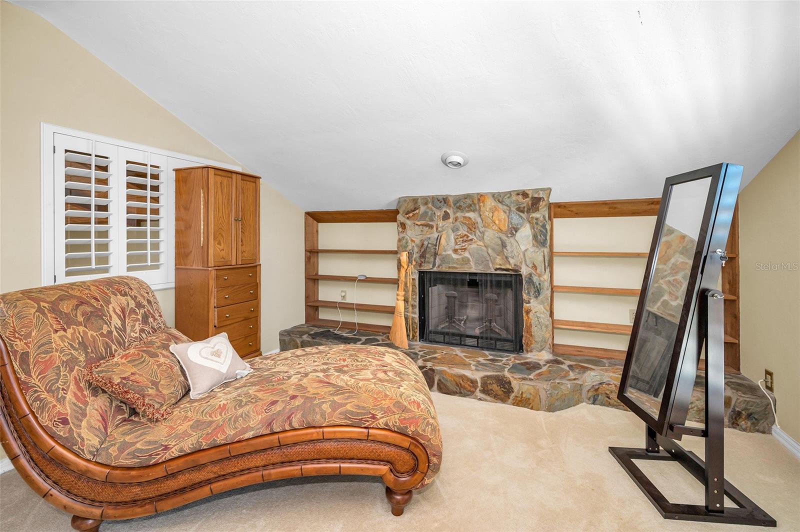 Primary bedroom with sitting area and fireplace