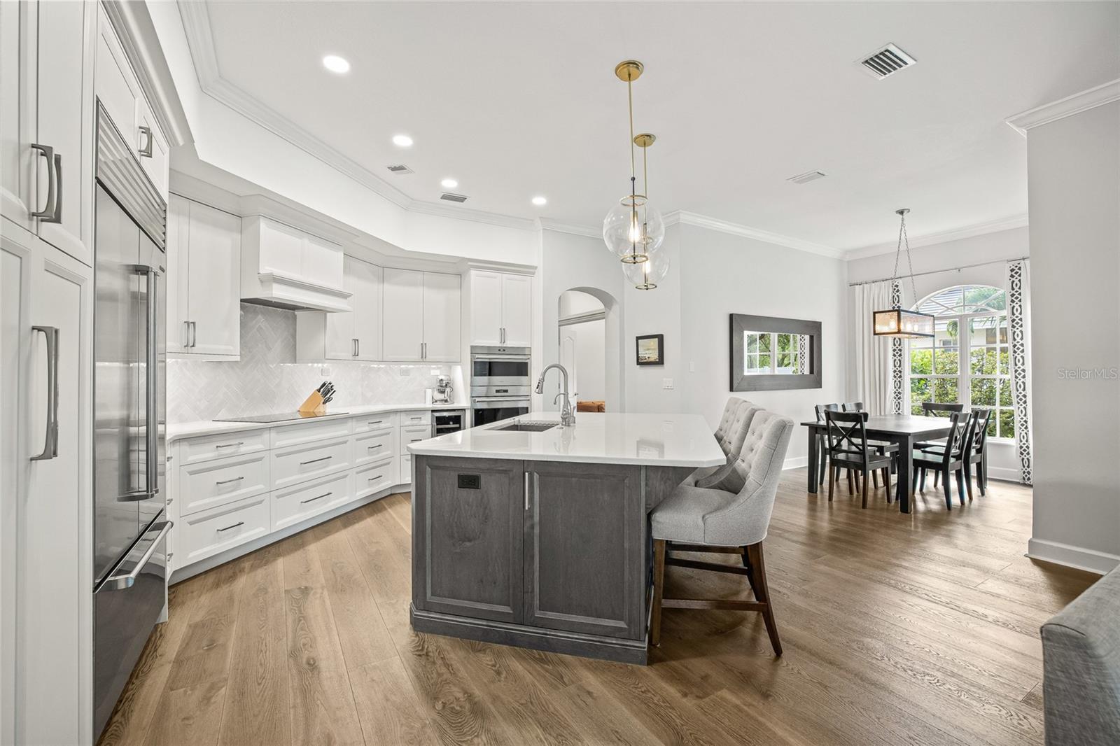 The kitchen island has amazing, custom pull out cabinets that can house your appliances, special liquors and more.