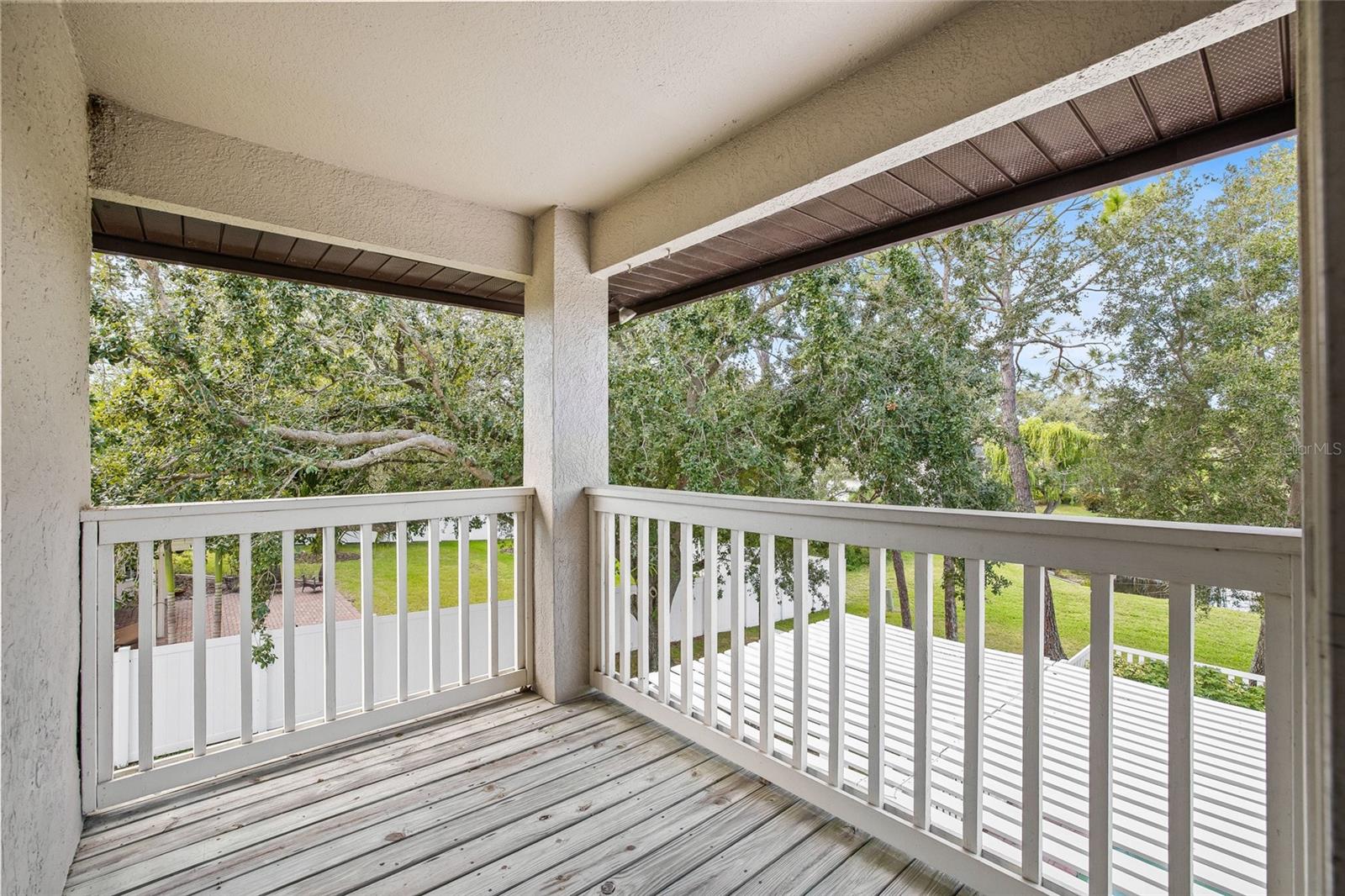 Covered balcony off of the Primary Bedroom. Perfect spot for yoga or morning coffee.