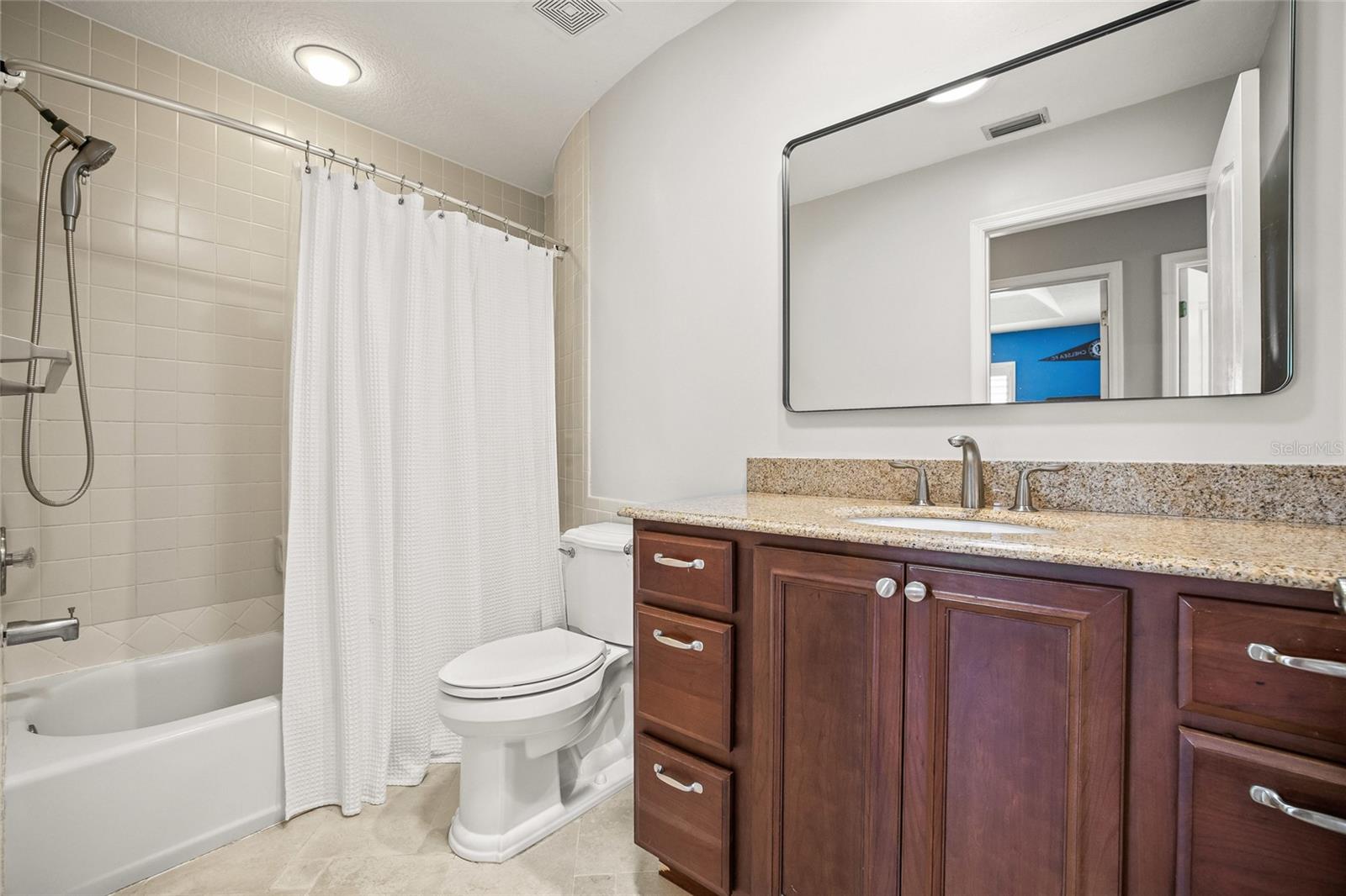 Full bathroom with granite counter and full tub serves the 3 other bedrooms upstairs.
