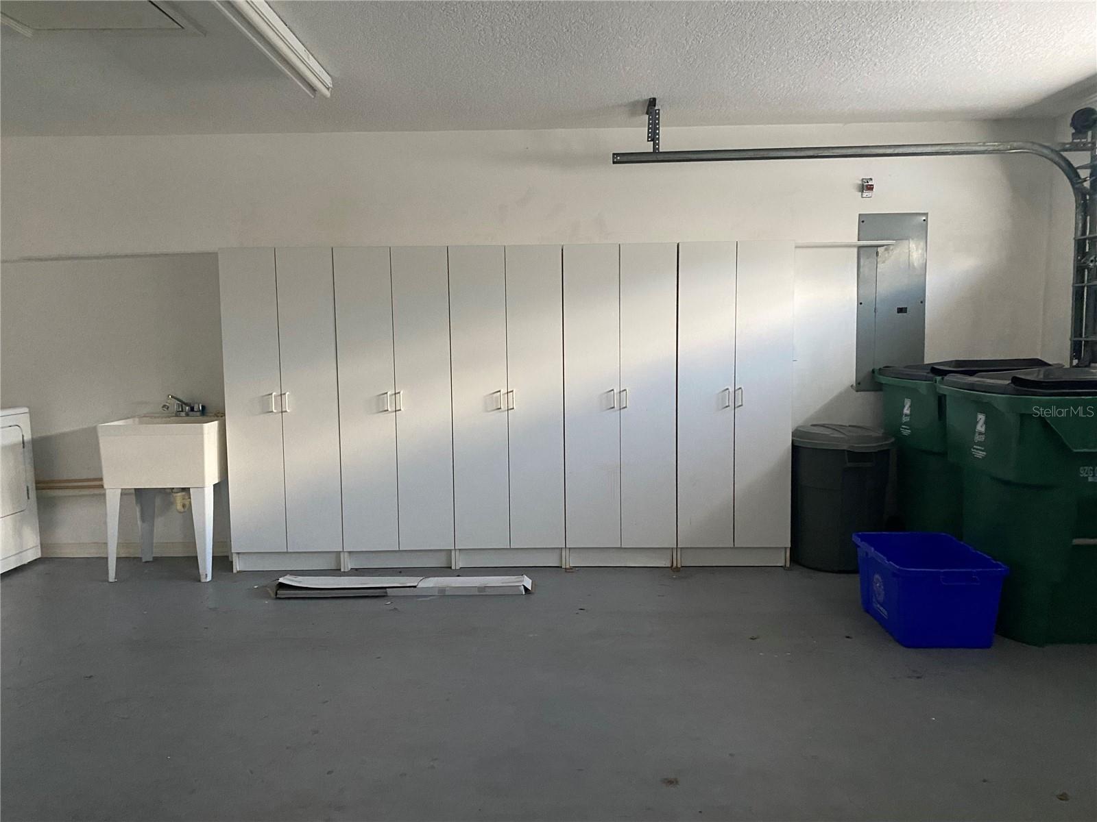 Garage with storage cabinets & wash tub
