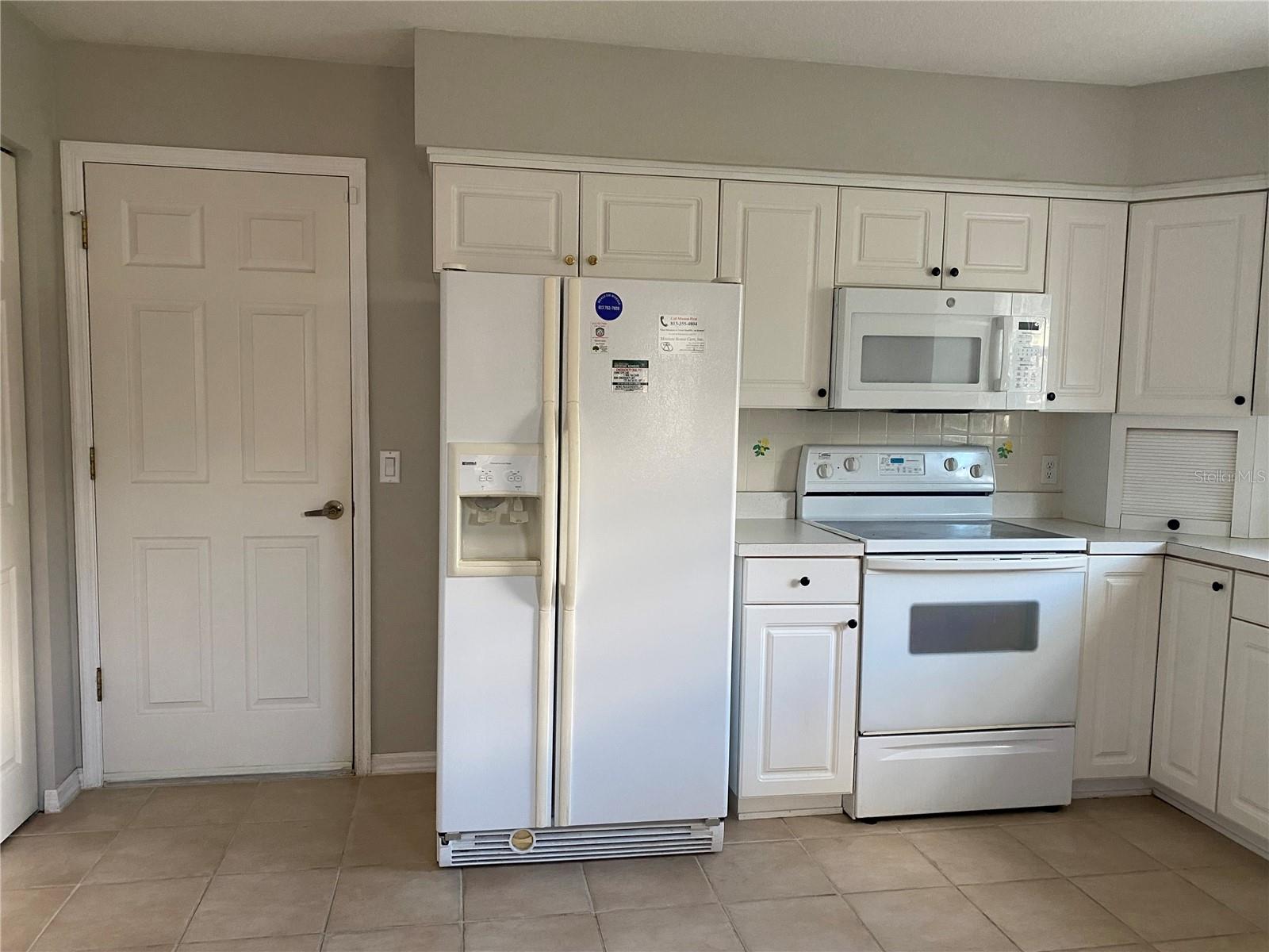 Kitchen and door to the garage is to the left