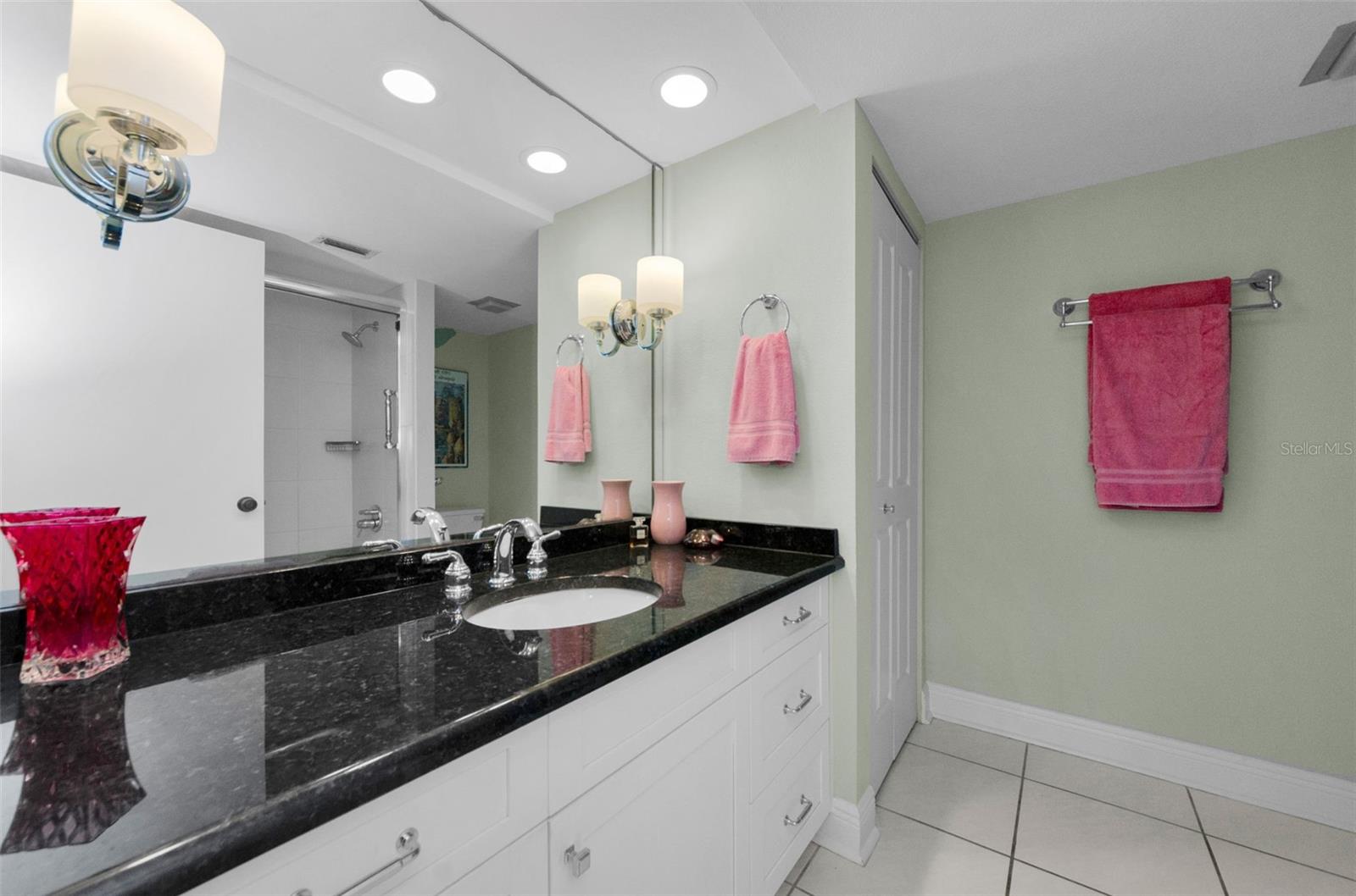 Master bath with spacious vanity and linen closet.