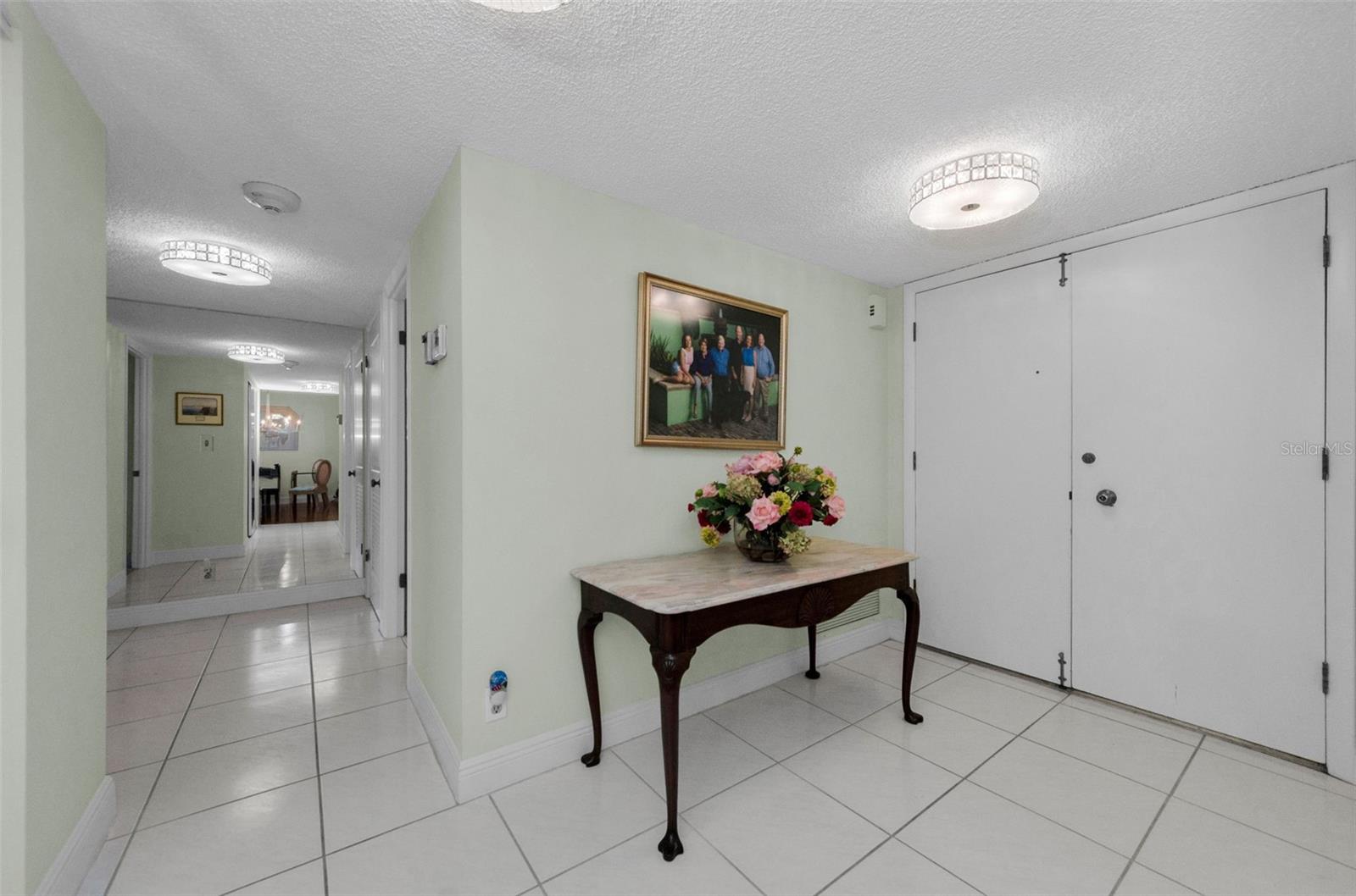 Large porcelain tile flooring. Hallway looking back to the bedrooms and baths.