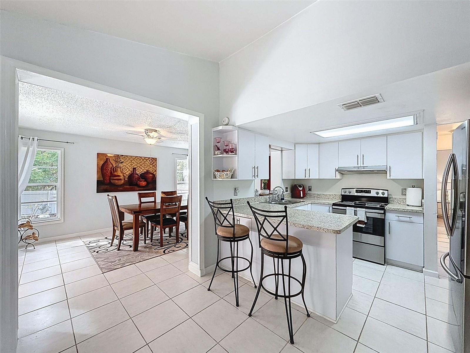 View from the breakfast / dining room leading to kitchen and second living or dining space.