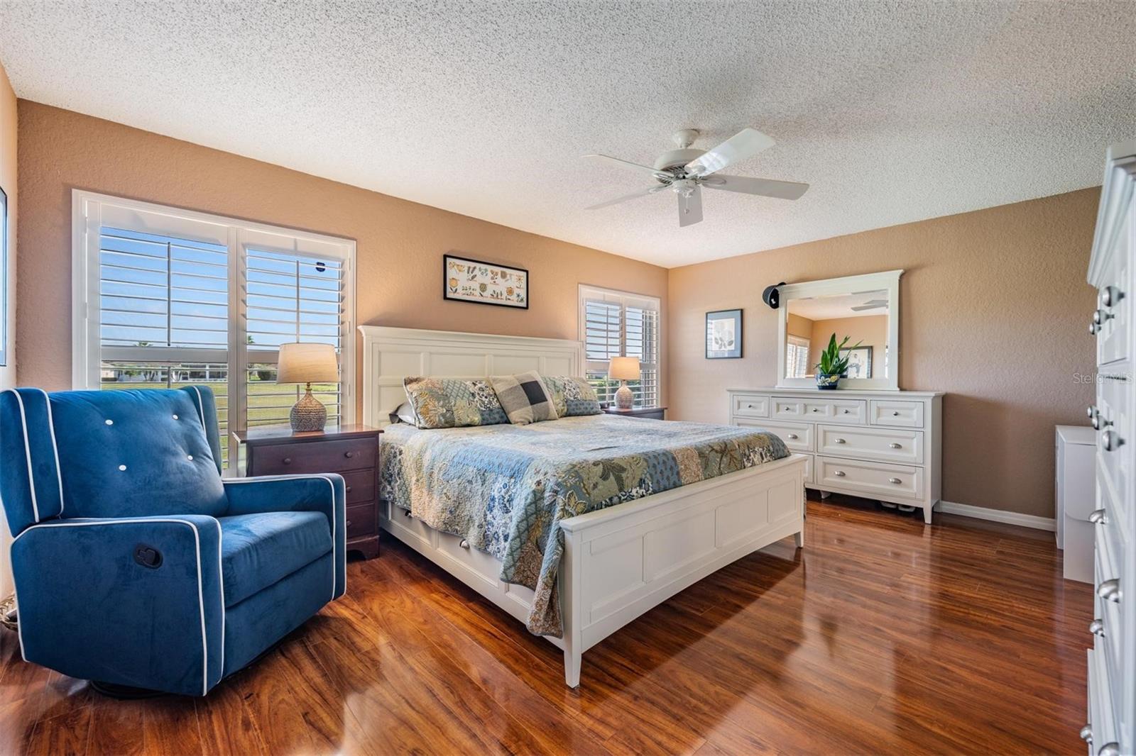 Primary bedroom with golf course/pond views with room for a cozy sitting area