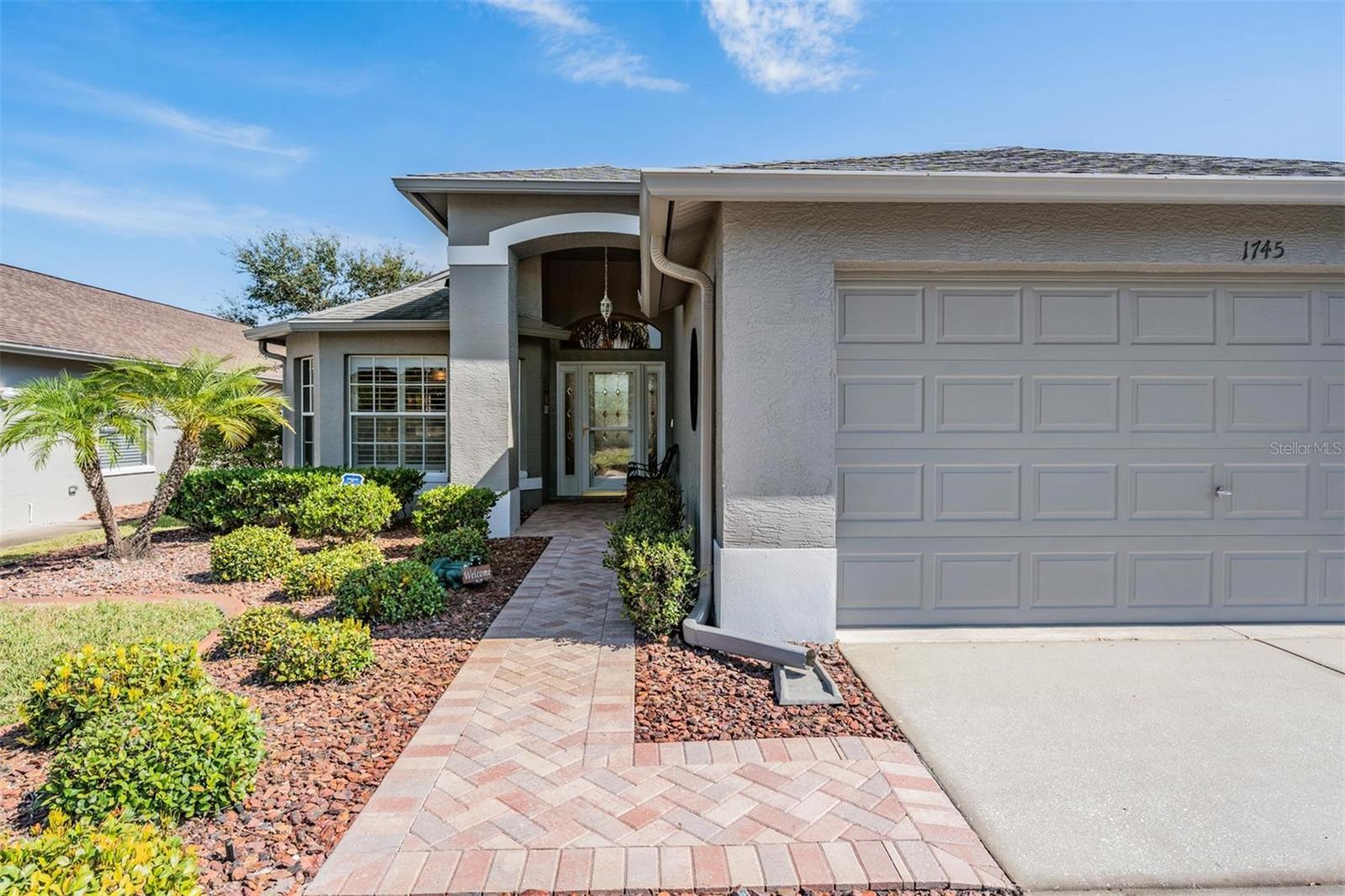 Beautiful glass door and pavered entry makes great first impression