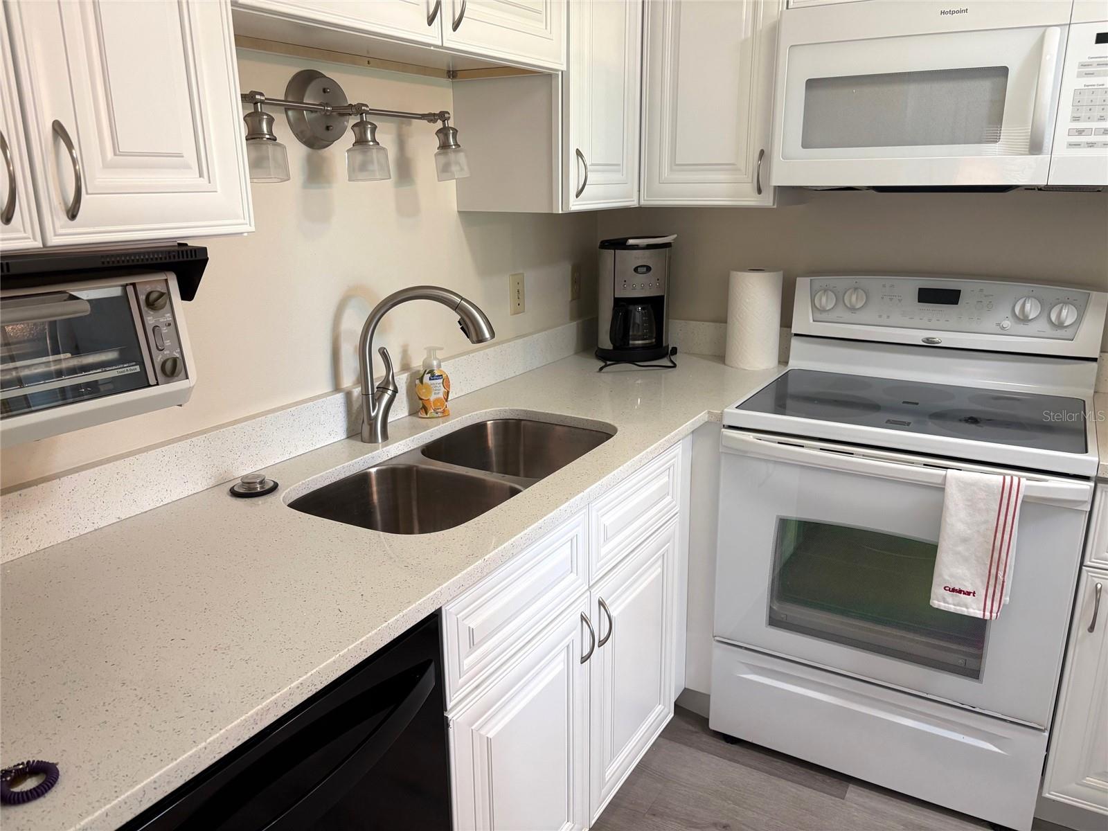 Kitchen Area with updated Cabinets and Corian counter tops