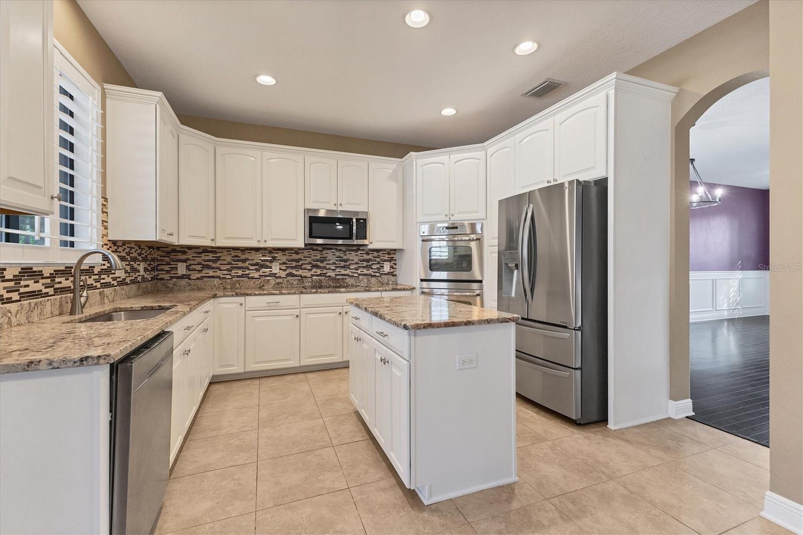 Kitchen offers handy access into formal dining room & living area too