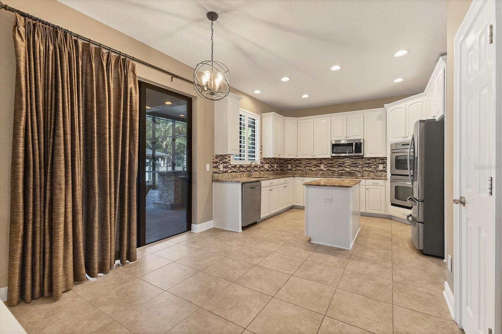 Breakfast nook is situated between kitchen and family room