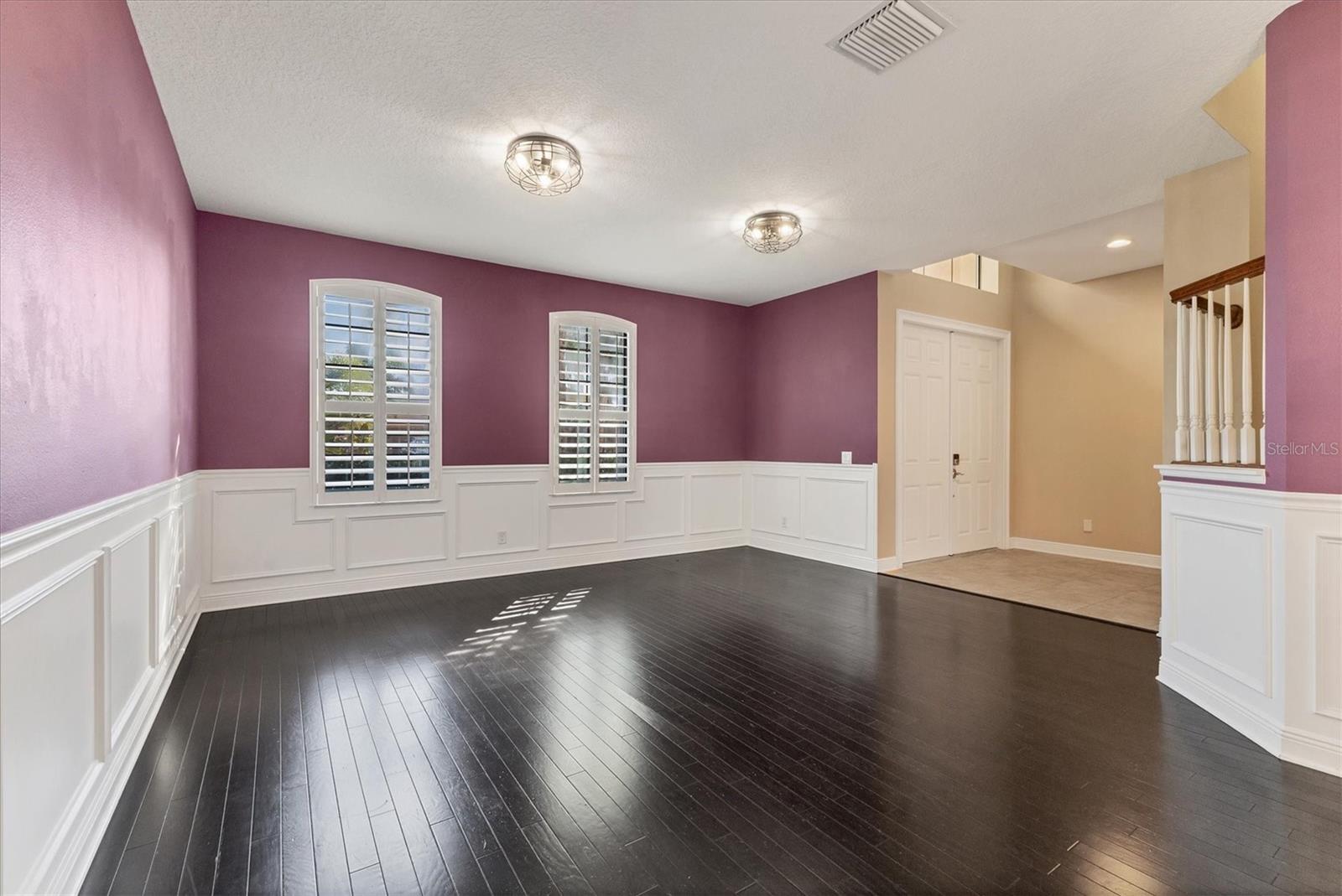 View from dining room to front living area and entry