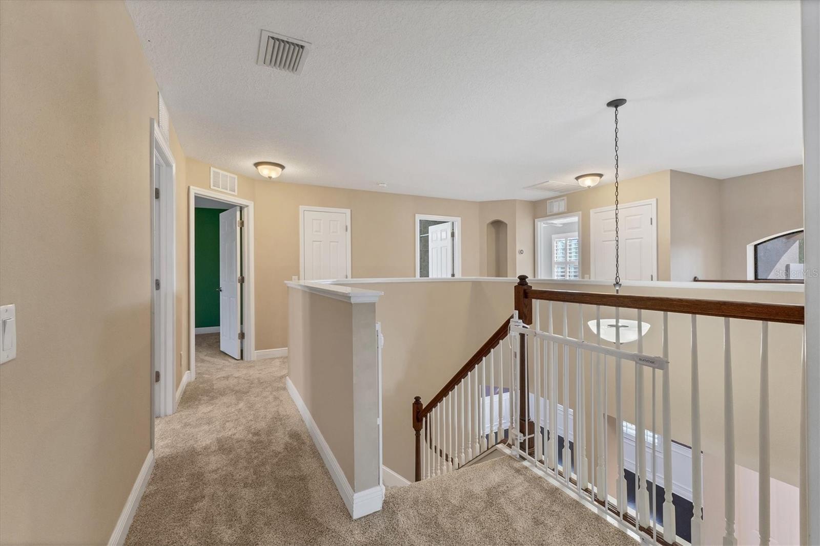 Second floor landing offers a glimpse across to secondary bedrooms and front window