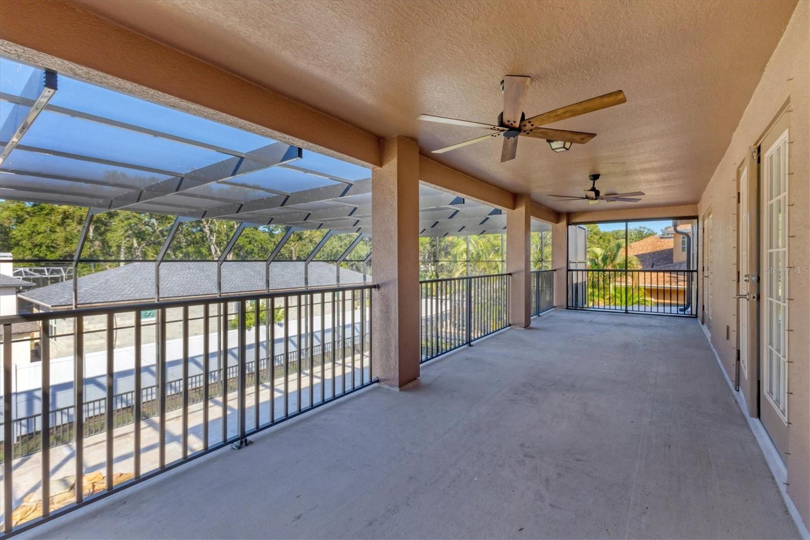 Upstairs deck off the Primary Suite is within the newly screened lanai