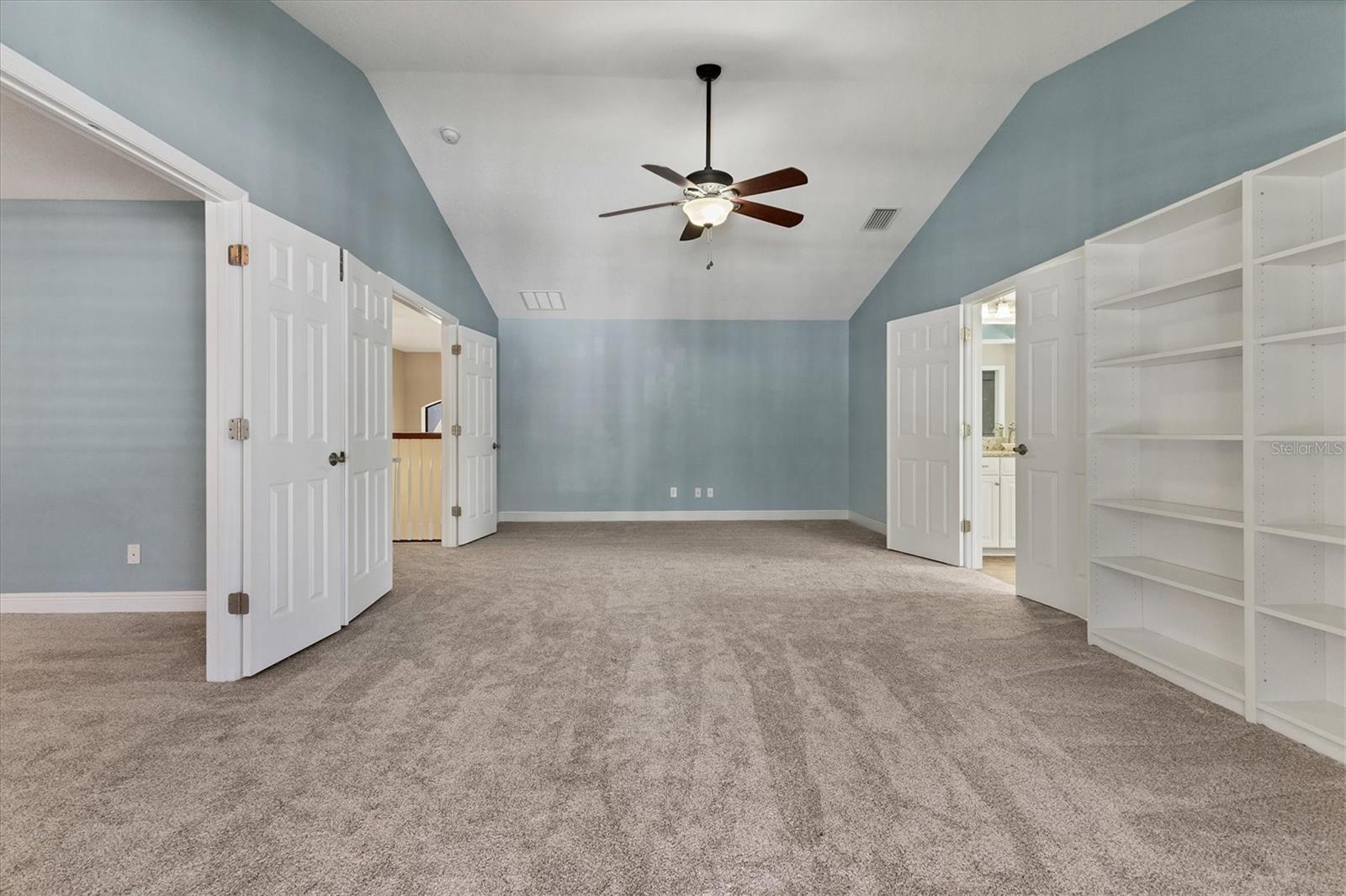 Spacious suite features double doors, new carpet and a vaulted ceiling with lighted ceiling fan
