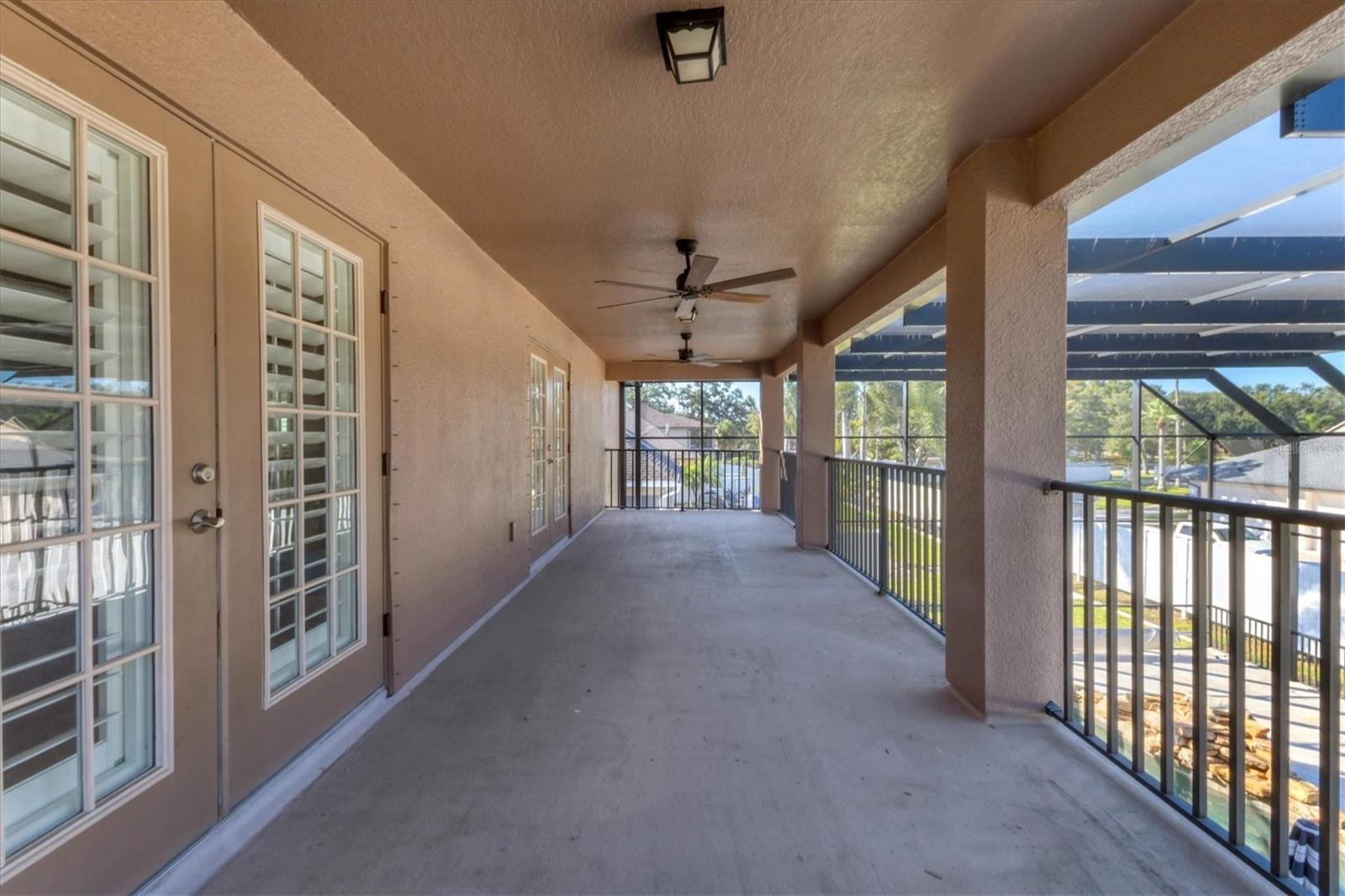 Spacious deck overlooking the pool and patio