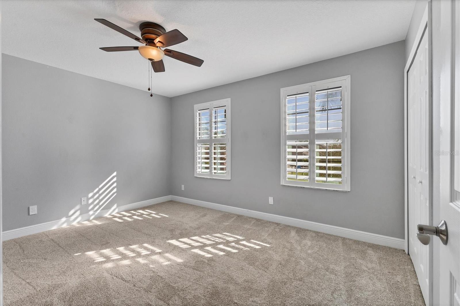 Front bedroom features windows with remote control blackout shades behind Plantation shutters to allow complete darkness...great for those daytime naps!