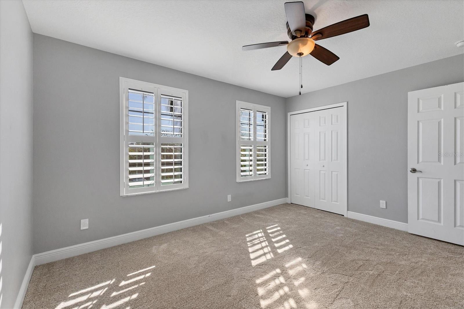Front bedroom has a lighted ceiling fan and walk-in closet with built-in organizer