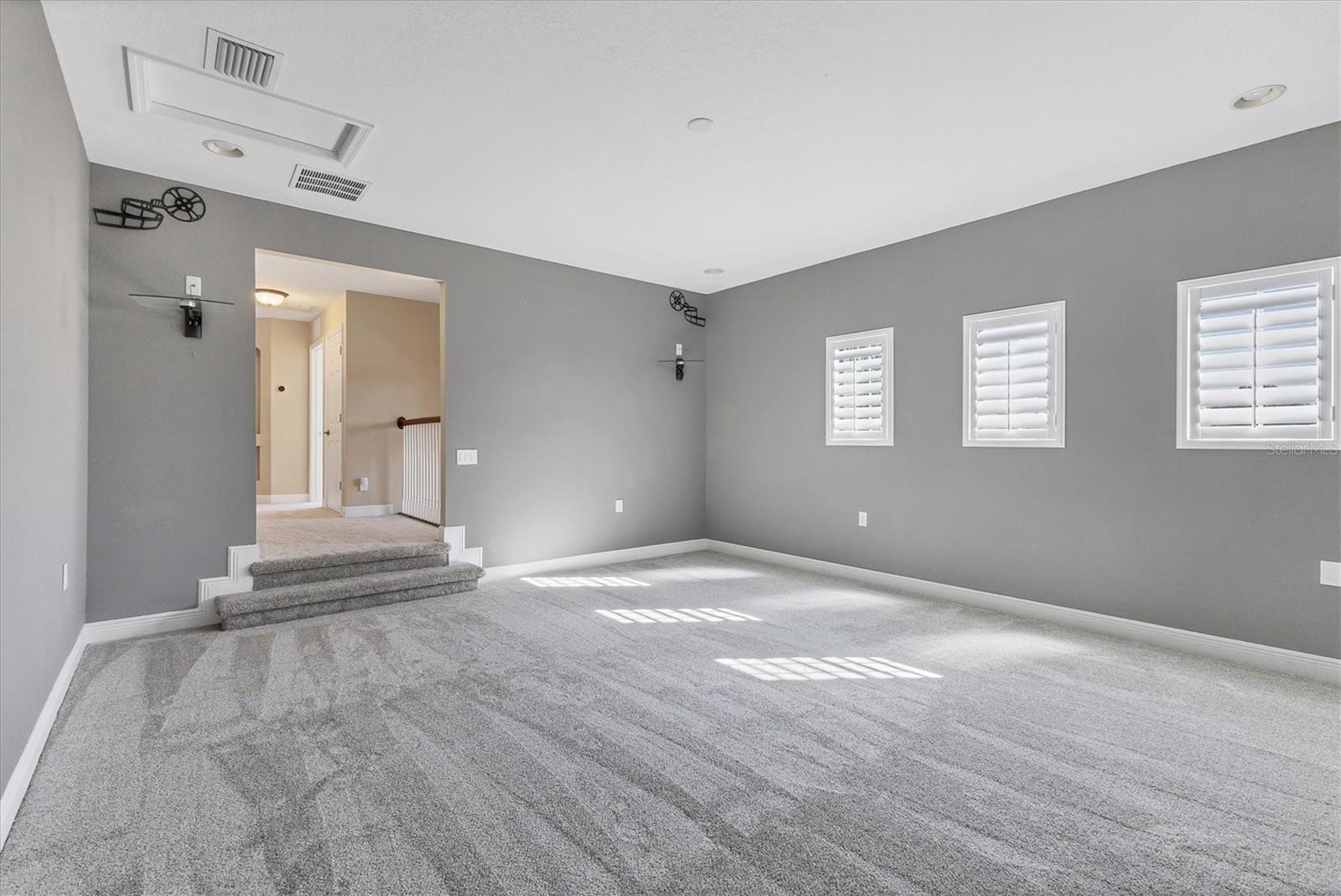 View out of Bonus Room with steps leading up into upstairs hallway