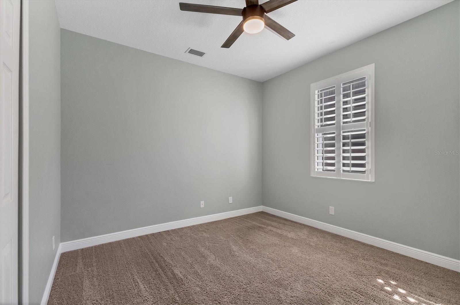Downstairs guest bedroom is situated adjacent to bathroom and laundry room