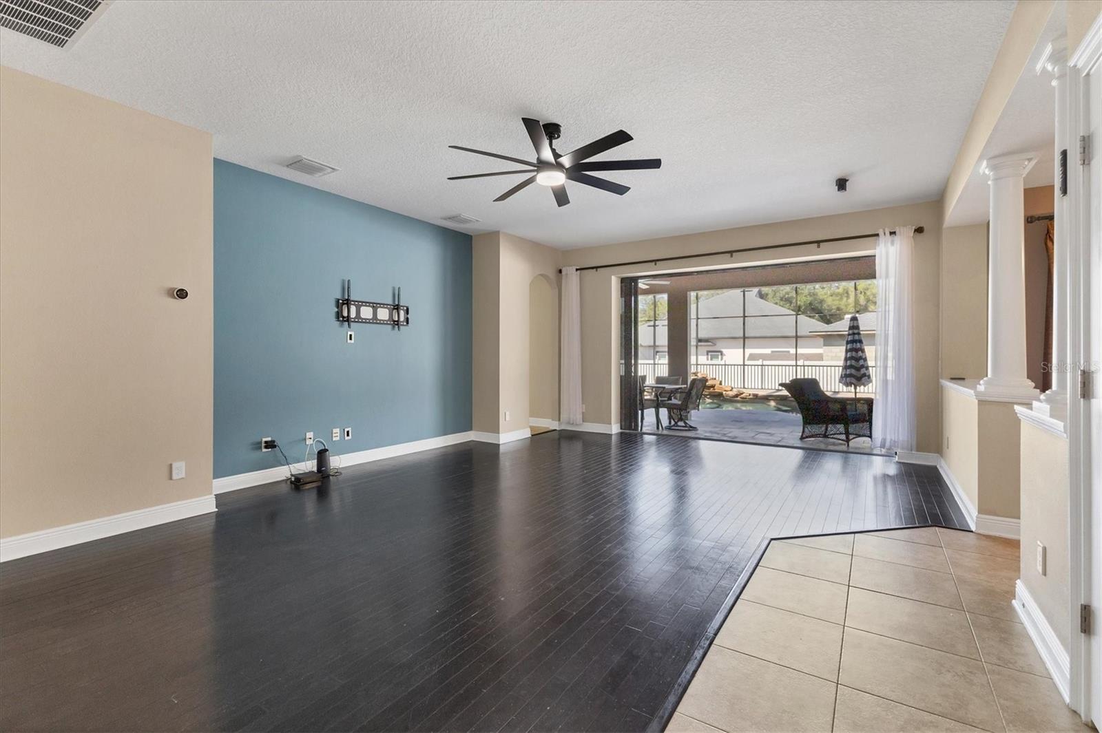 Spacious family room overlooking the pool & patio.  Notice the sliding glass doors that disappear behind the wall.