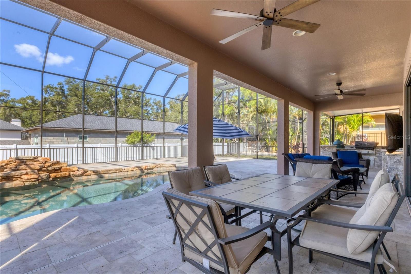 The large covered patio with ceiling fans is ideal for dining al fresco
