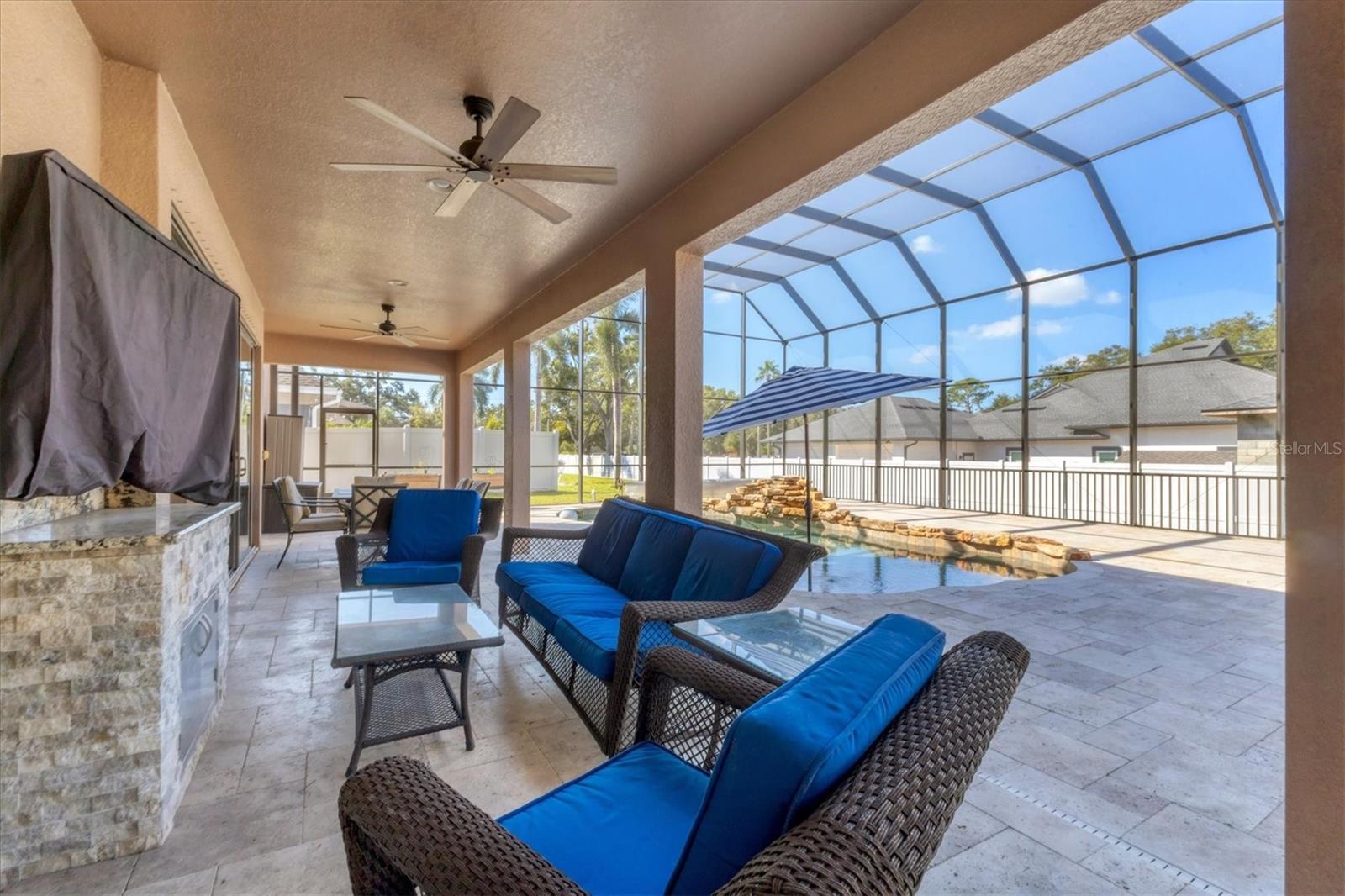 Outdoor living area with wall mounted TV is great for game days!