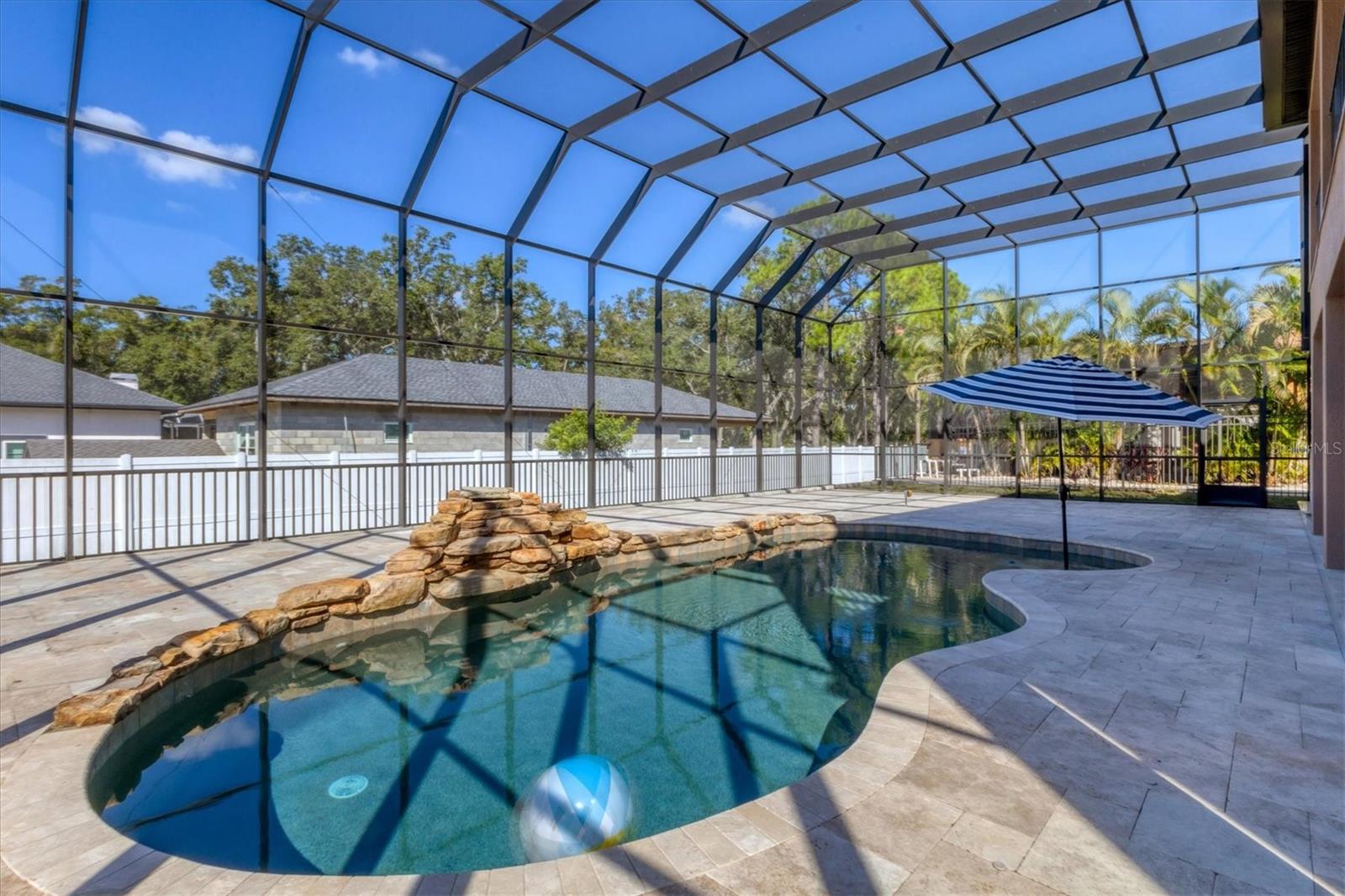 Travertine stone deck was recently extended and a brand-new screen enclosure was added in 2025.