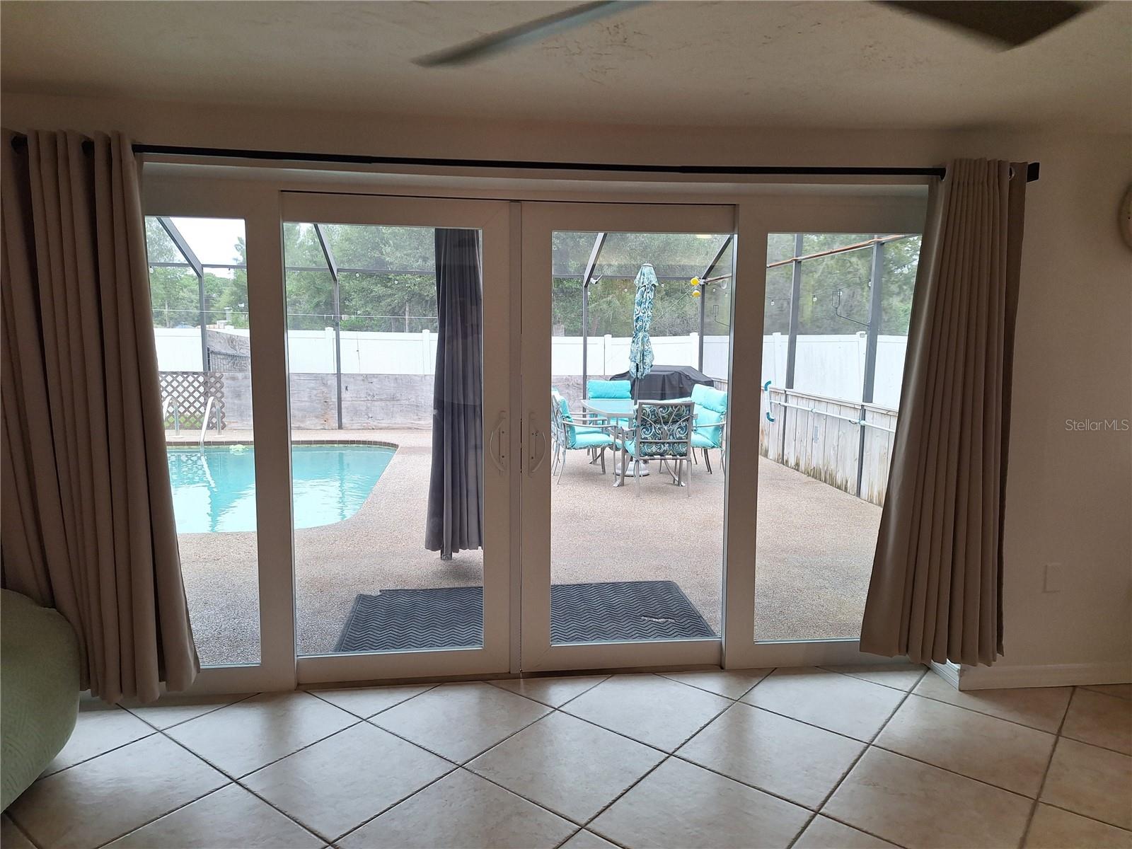 Four Panel Storm Sliders open up entire wall to Pool